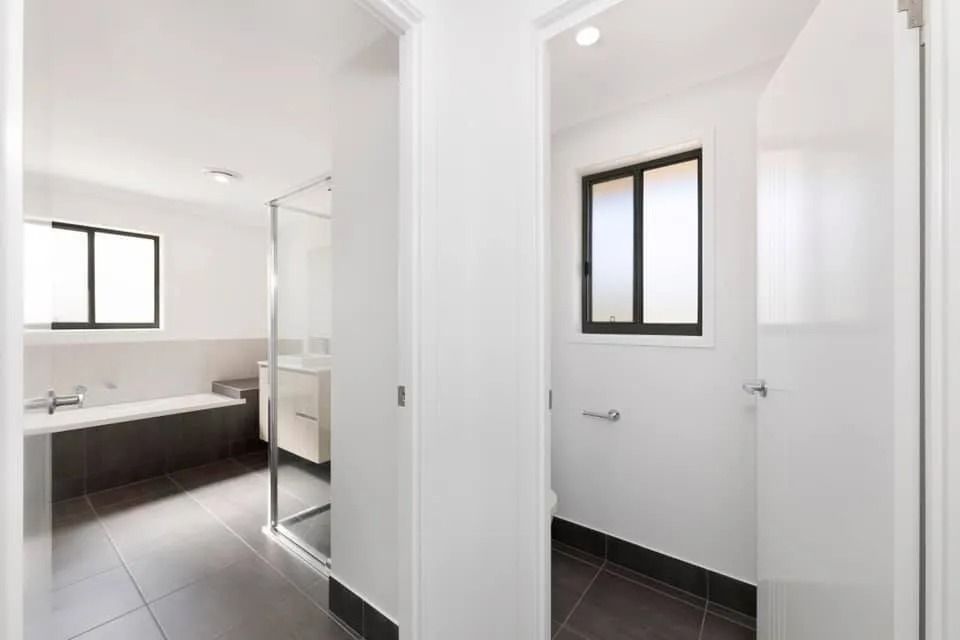 Bathroom Interior with White Walls, Dark Gray Tile Flooring — Country to Coast Homes In Gregory River, QLD