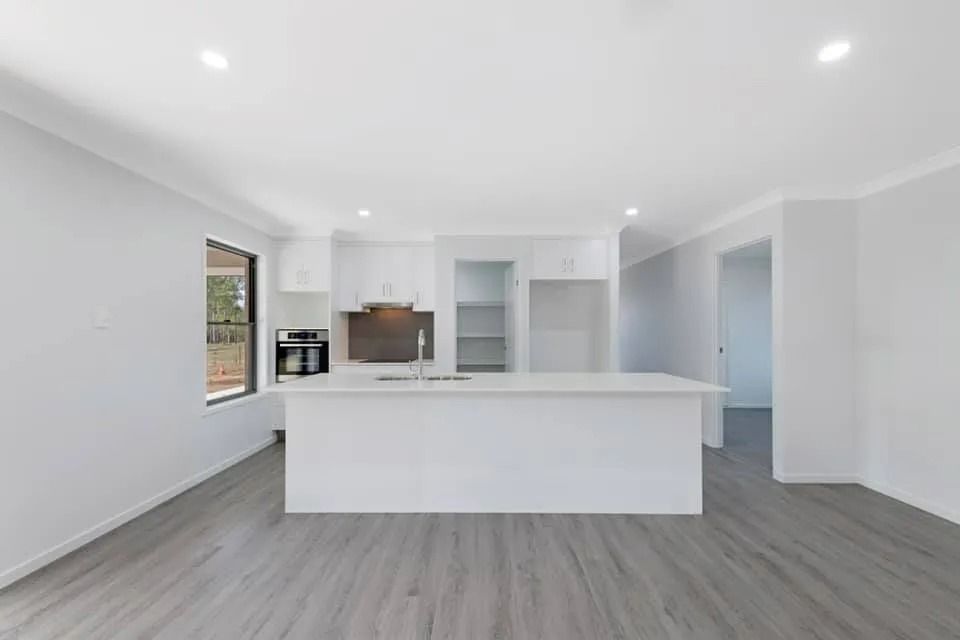 Bright, Modern Kitchen with White Cabinets, Island — Country to Coast Homes In Gregory River, QLD