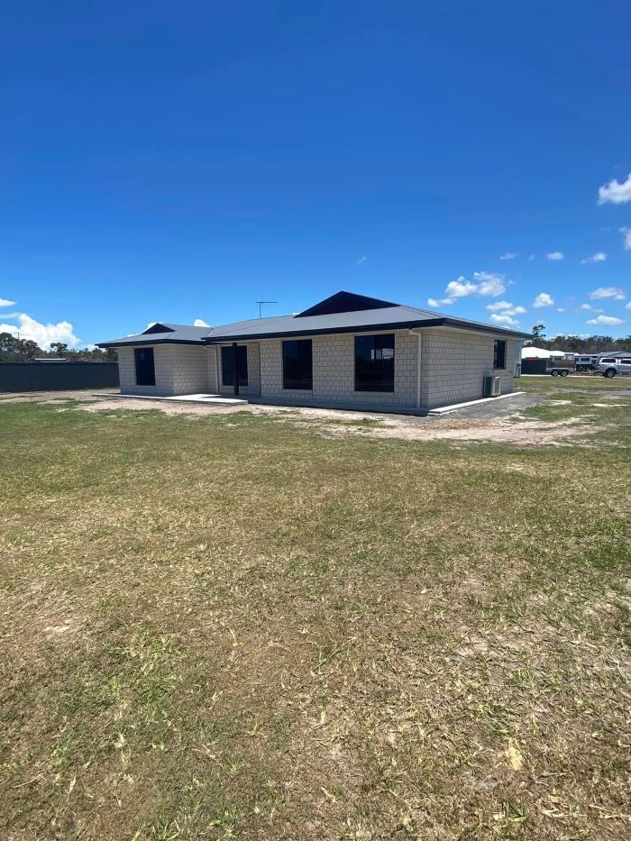 A One-Story House with A Dark Roof and Black Window Frames — Country to Coast Homes In Gregory River, QLD