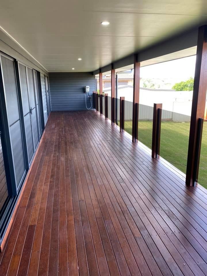 Wooden Deck Extending Along a House, Framed by Dark Posts — Country to Coast Homes In Gregory River, QLD