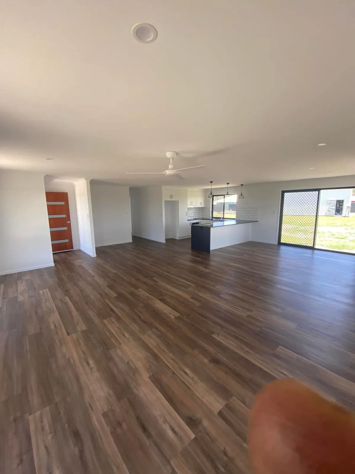 Interior View of A New Home with Dark Wood Floors, White Walls, and A Kitchen Island — Country to Coast Homes In Gregory River, QLD