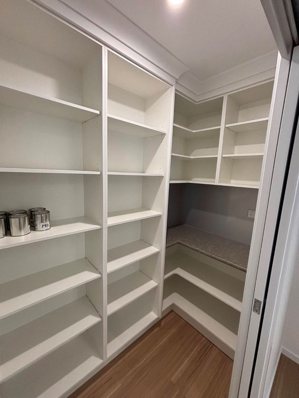 Empty White Pantry with Built-In Shelves, on A Wooden Floor — Country to Coast Homes In Bundaberg, QLD