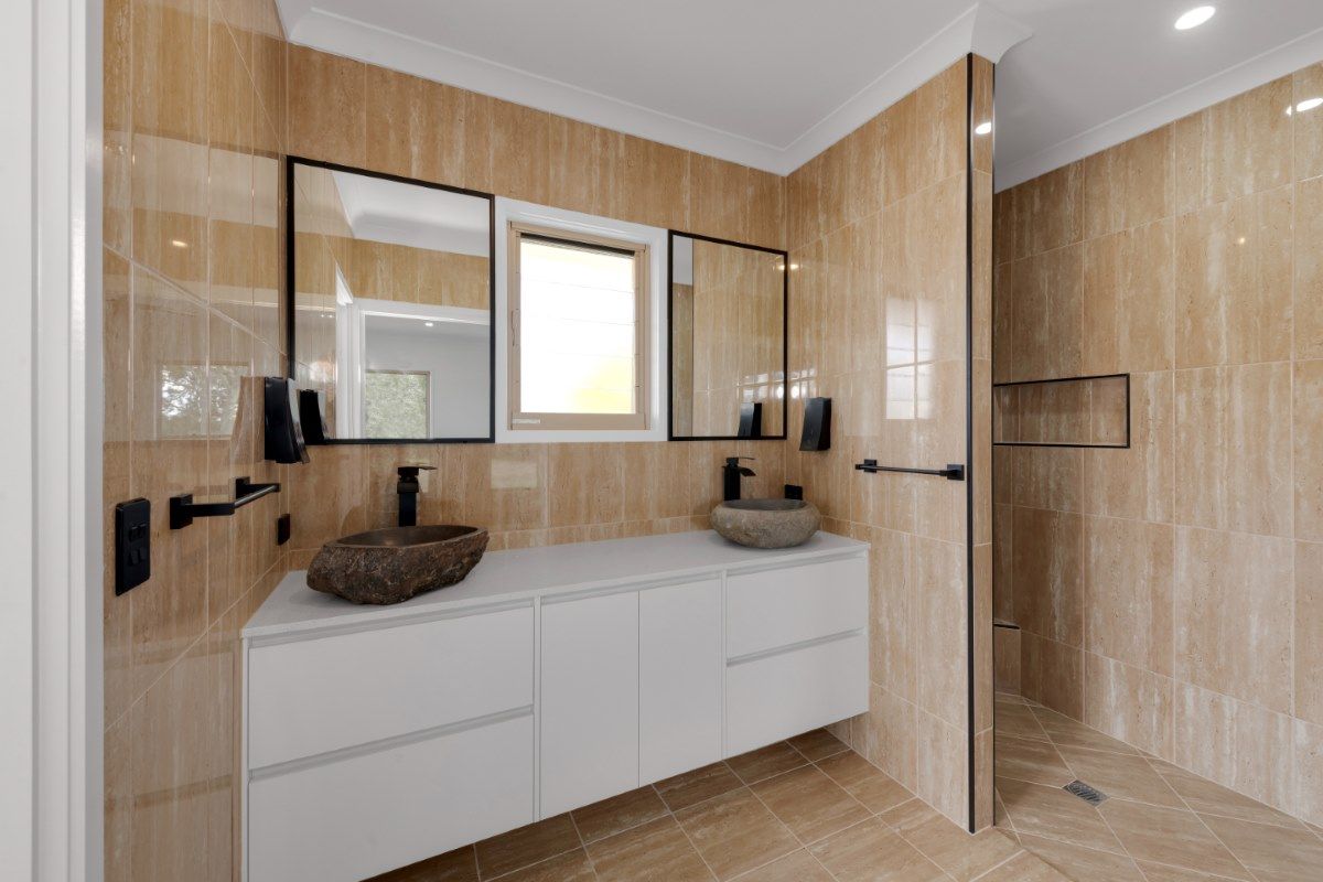 Modern Bathroom with Beige Tiled Walls and Floor — Country to Coast Homes In Childers, QLD