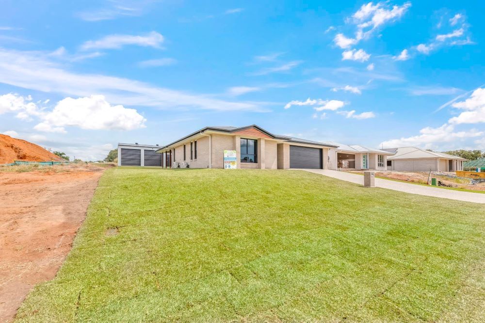 A Newly Built, Single-Story House with A Green Lawn — Country to Coast Homes In Woodgate, QLD