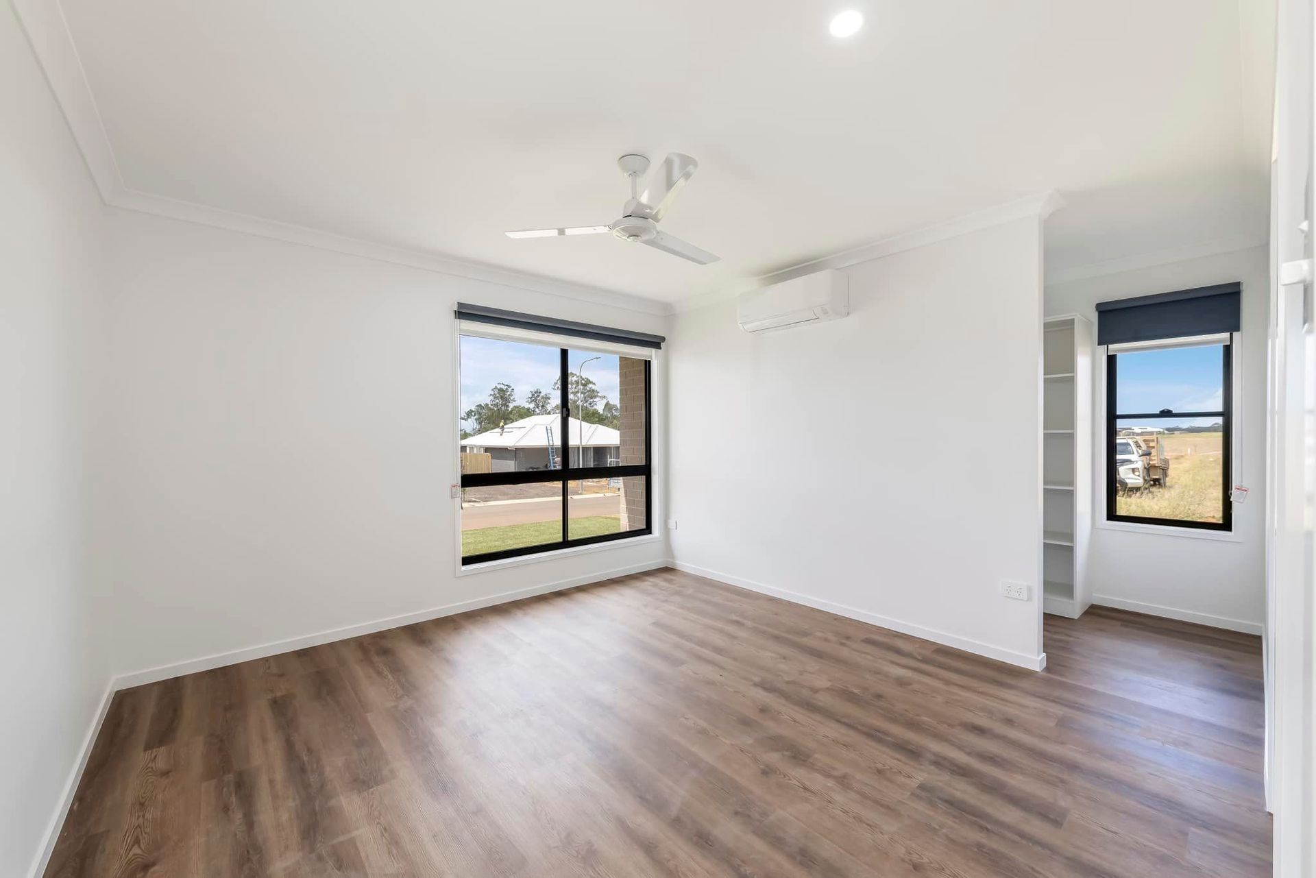 Empty Bedroom with Wood-Look Floors, White Walls — Country to Coast Homes In Woodgate, QLD