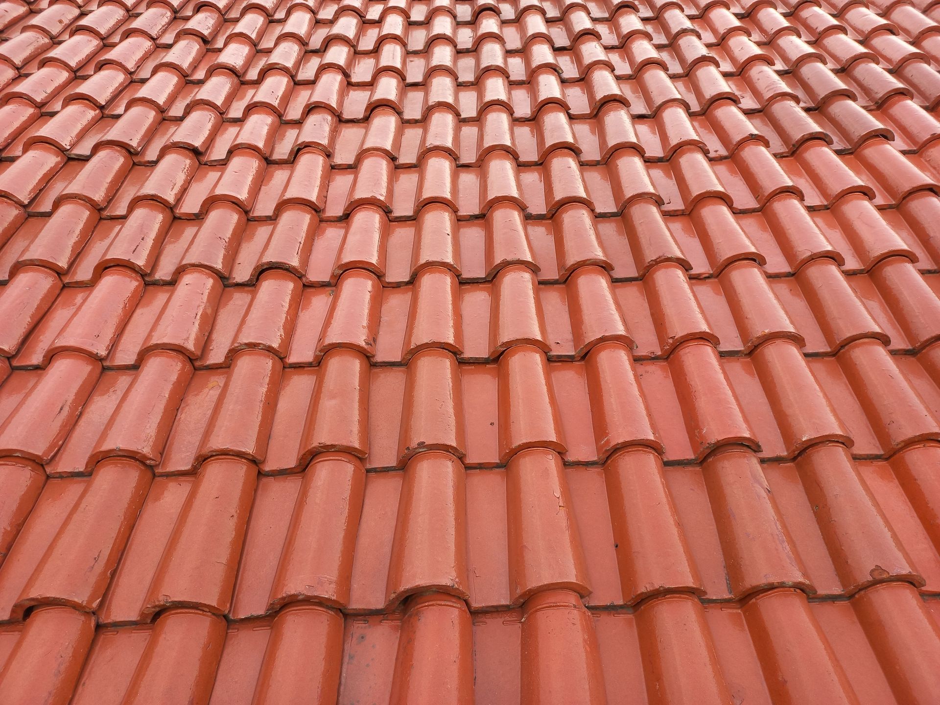Red terracotta roof tiles in a repeating pattern, viewed from above