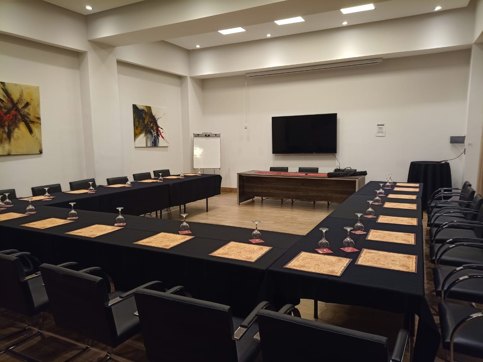 A conference room with tables and chairs set up for a meeting