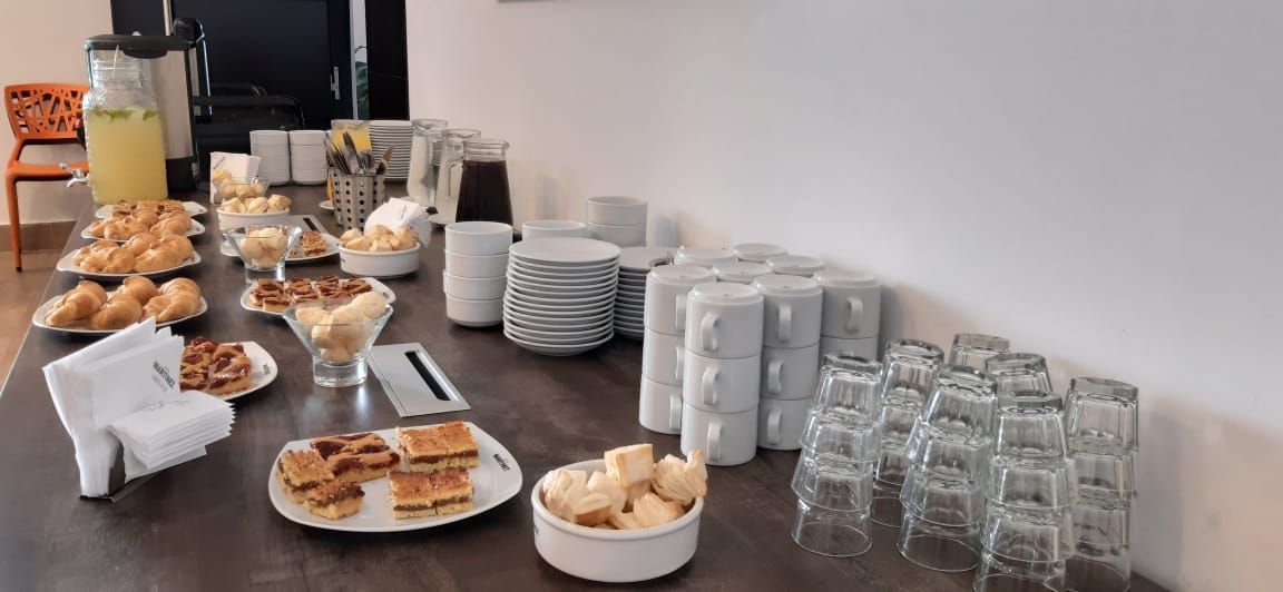 A table with plates of food and glasses on it.
