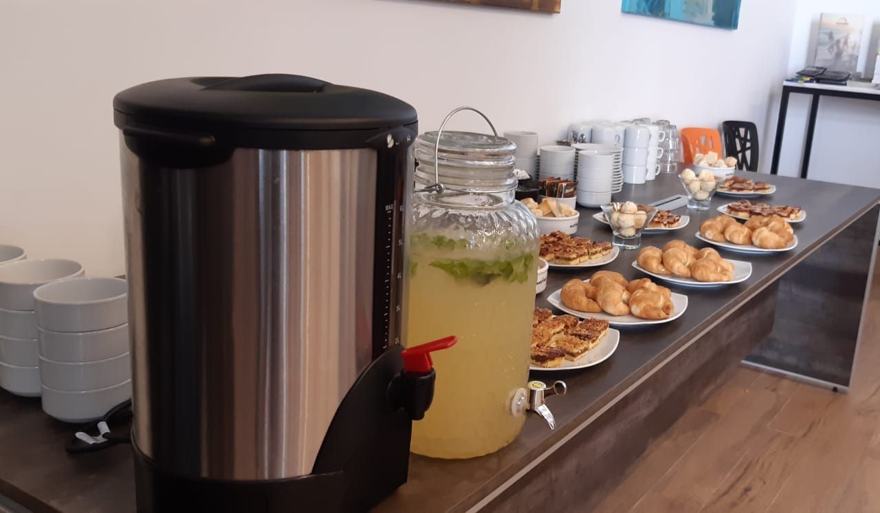 A table with plates of food and a pitcher of lemonade on it.