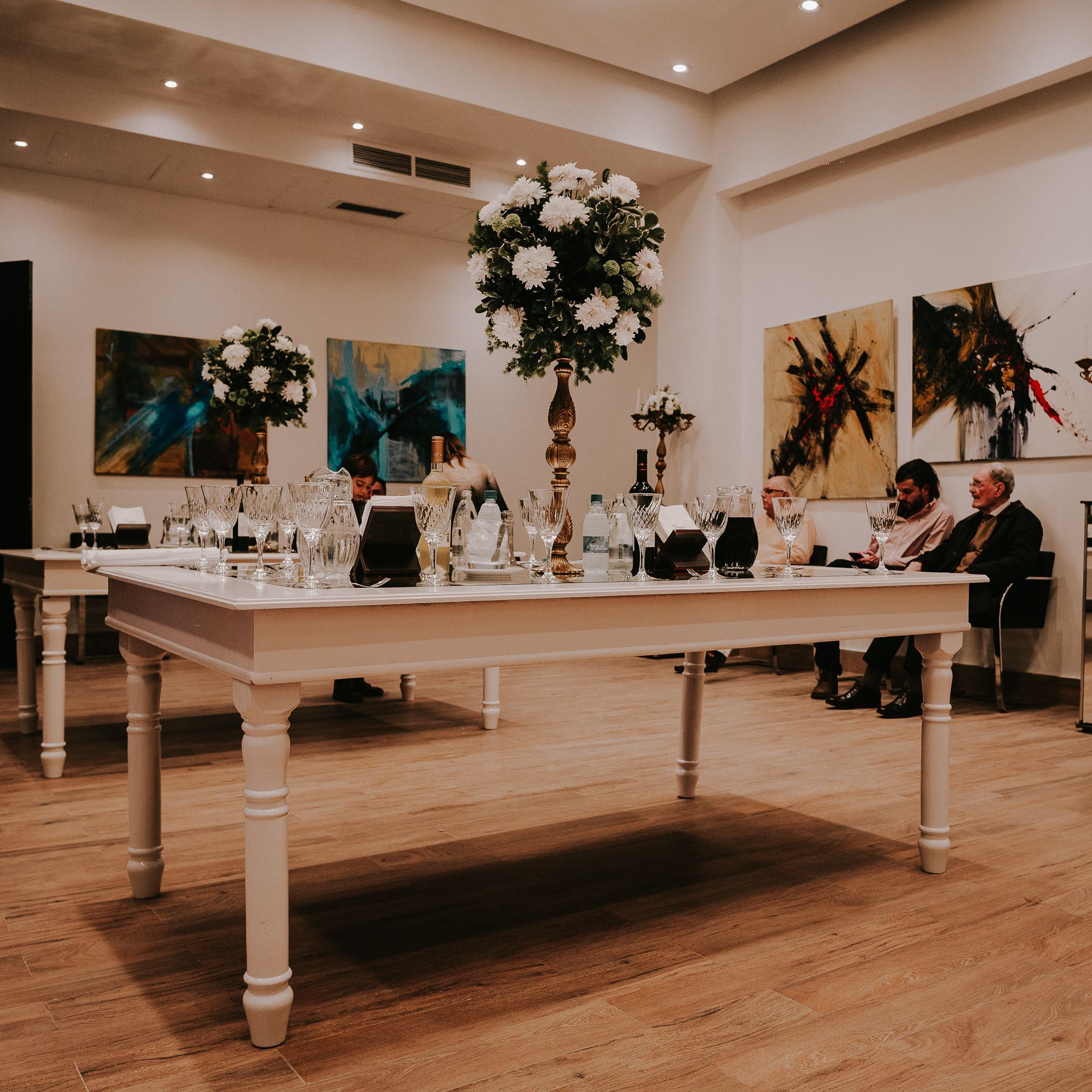 A table with a vase of flowers on top of it