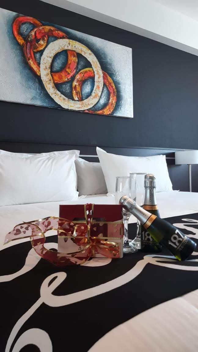 A hotel room with a painting of pretzels on the wall