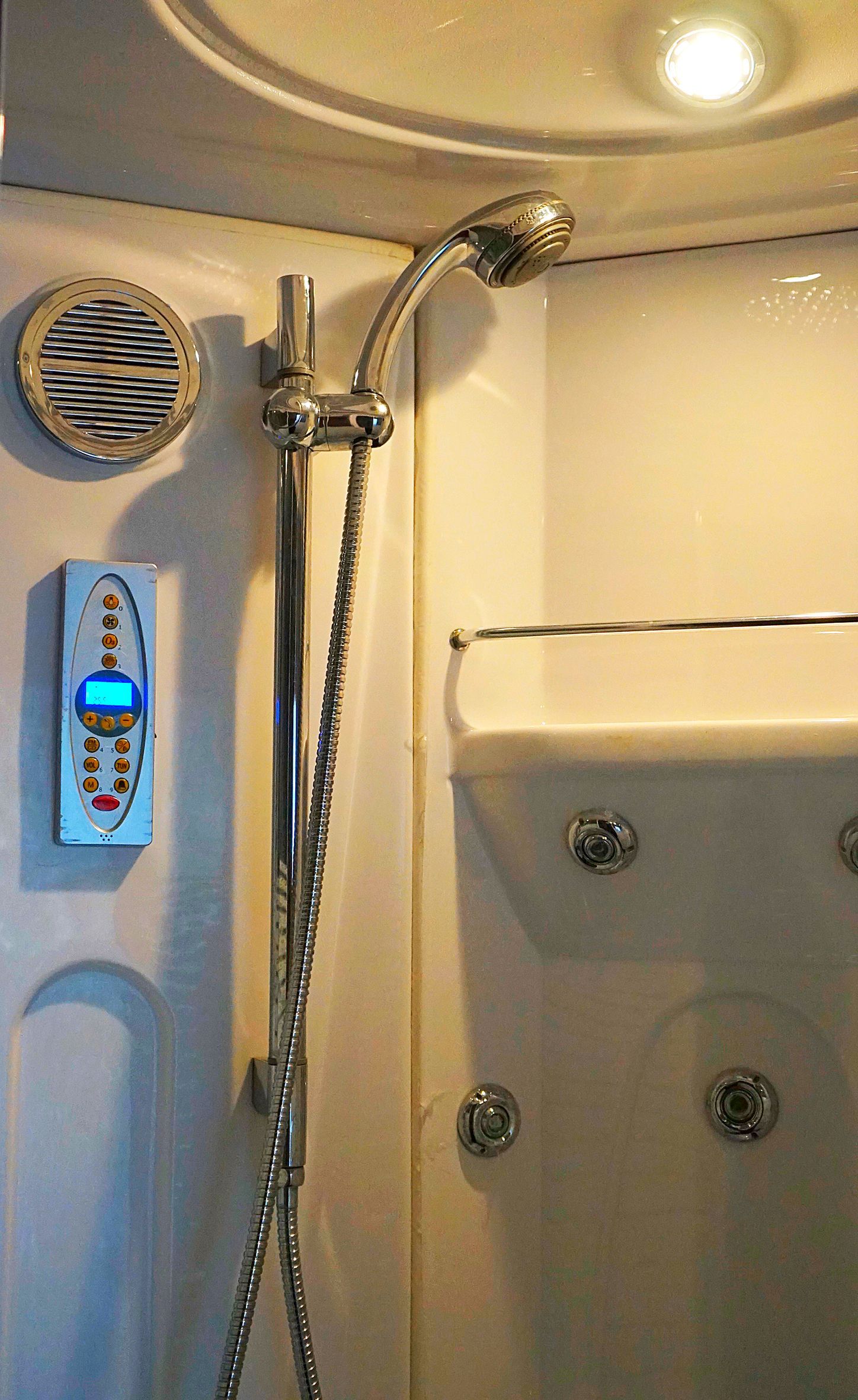 A close up of a shower head in a bathroom