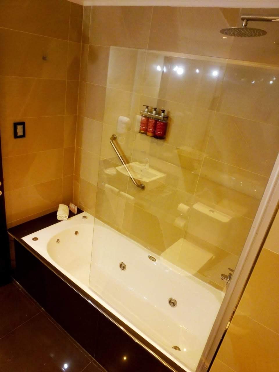 A bathroom with a bathtub and a shower