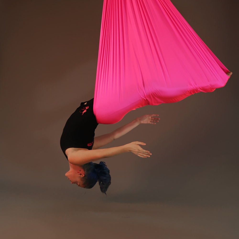 woman performing aerial yoga