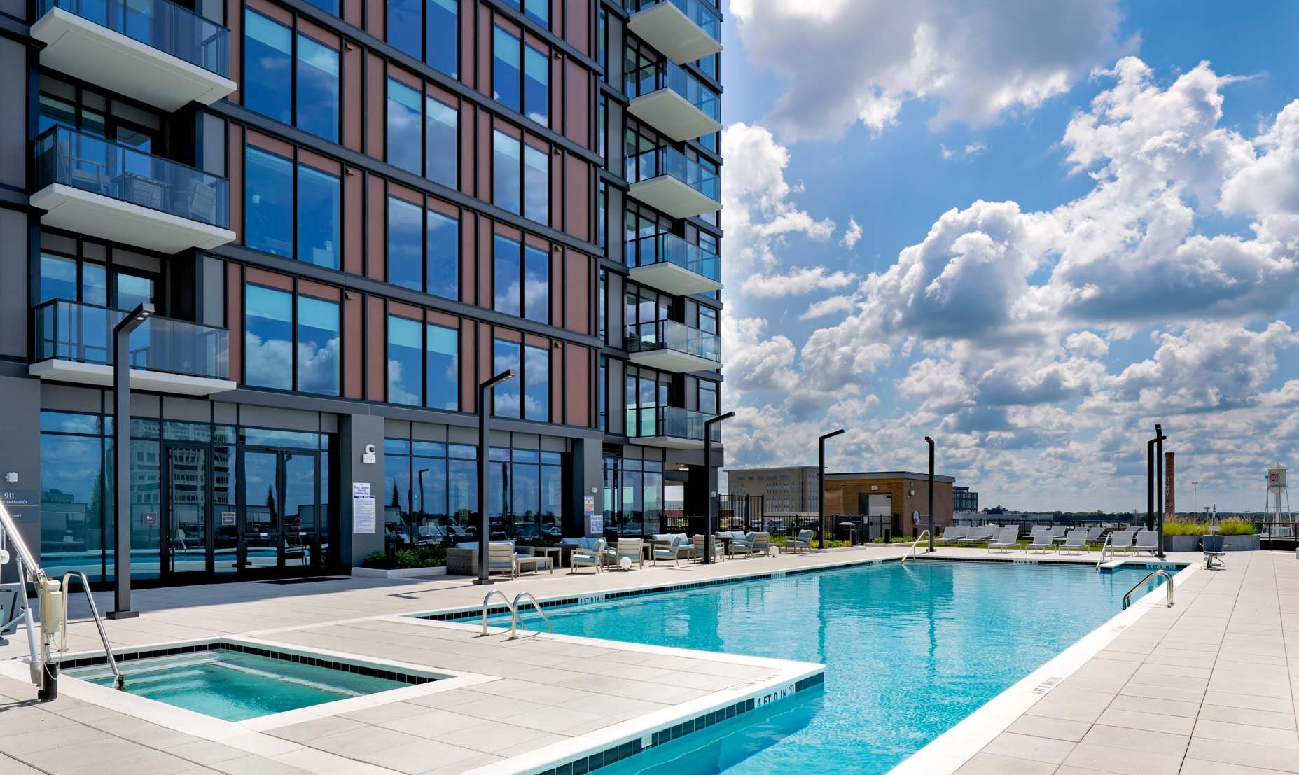 An aerial view of a building with a pool on the roof