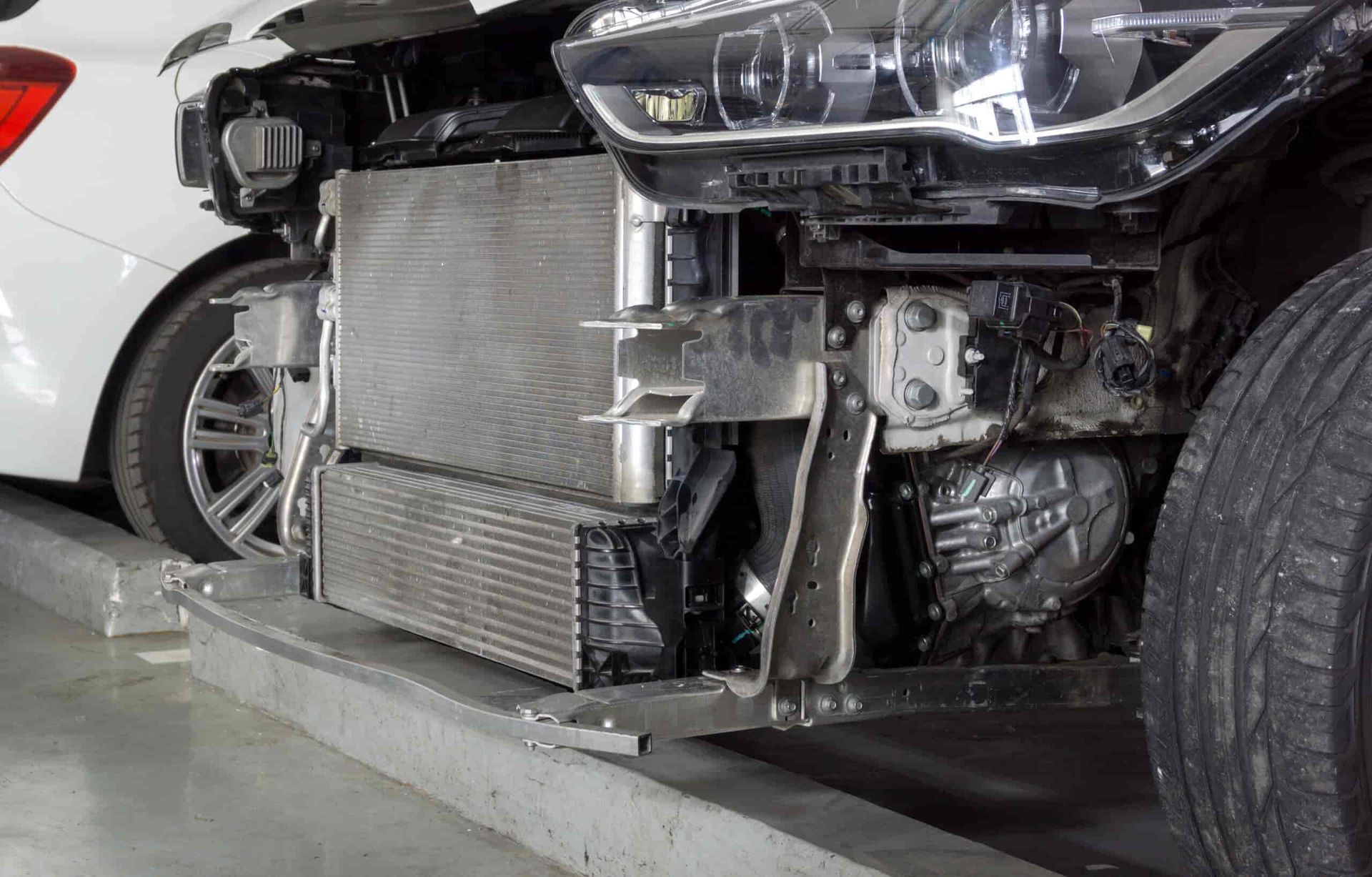 A White Car is Being Repaired in a Garage — Wyong Radiator Repairs In Terrigal, NSW