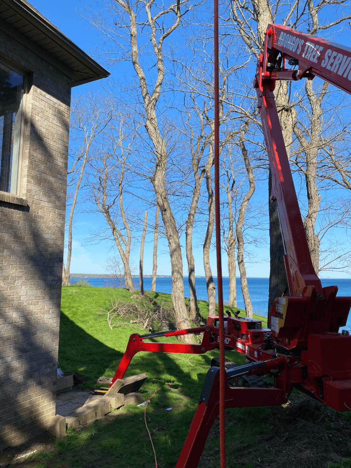 A red crane with a sign that says ' aerial lift ' on it