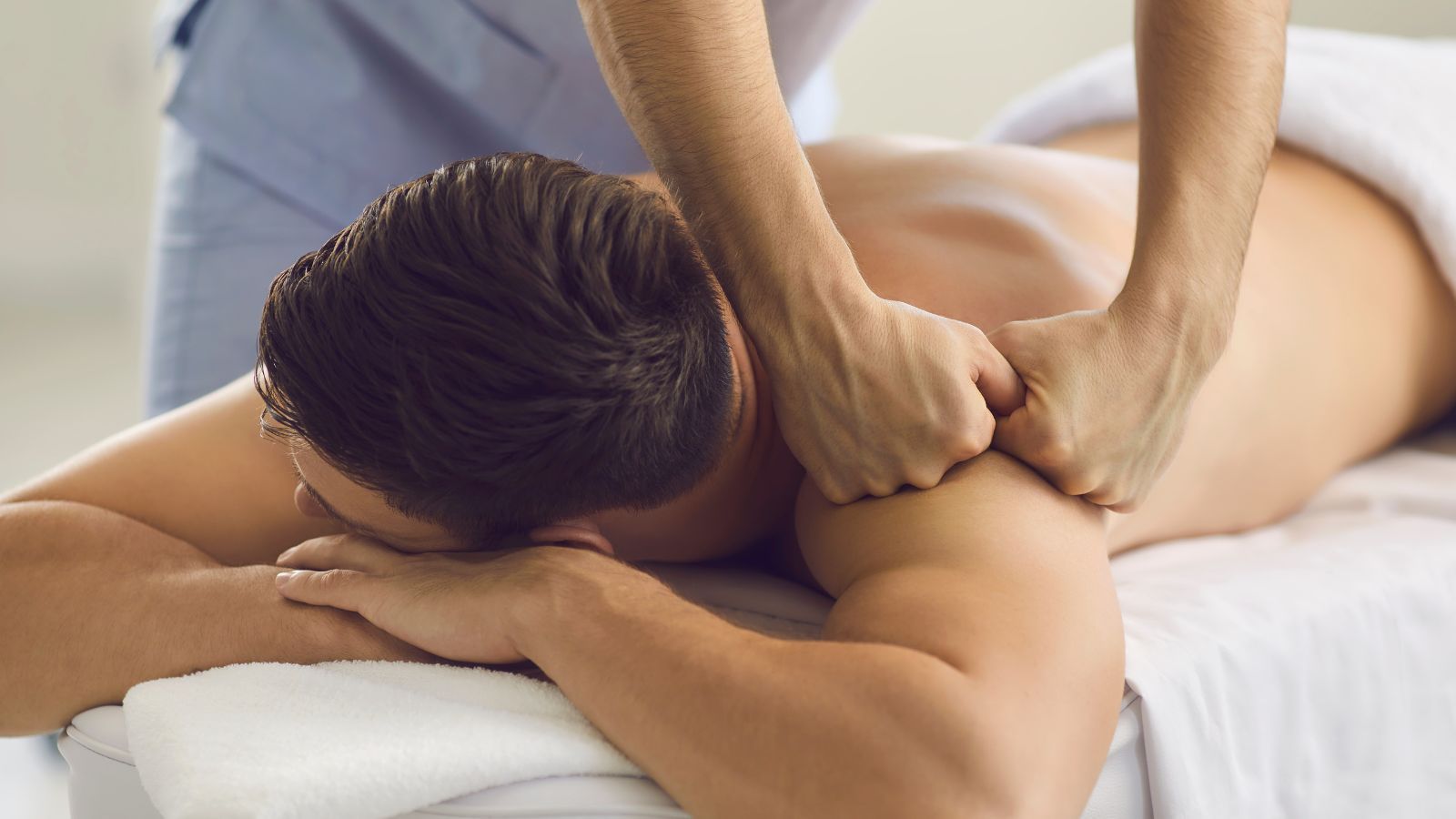 massage therapist learning on patients at a hybrid massage therapy school
