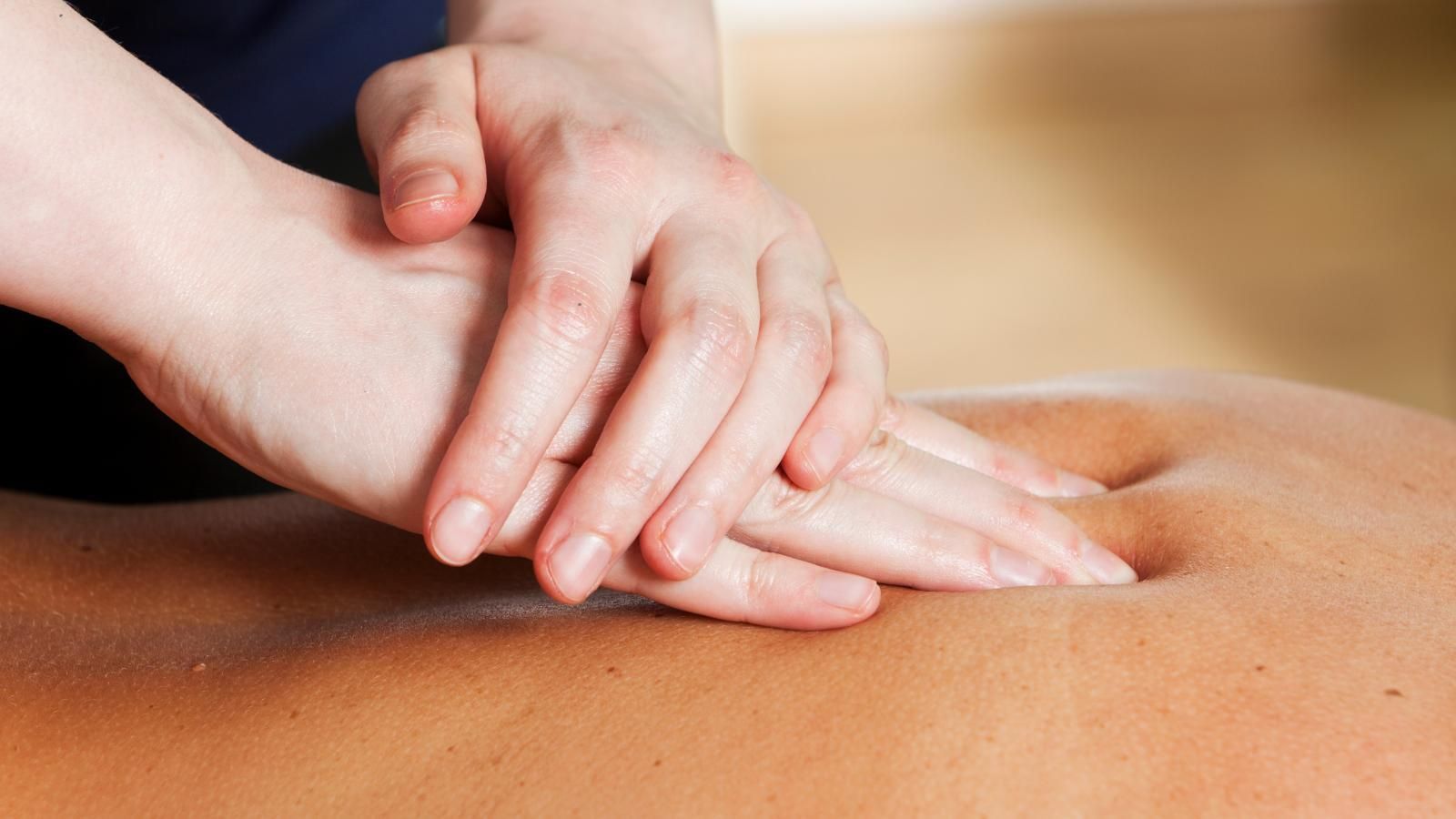 A person is getting a massage from a student.