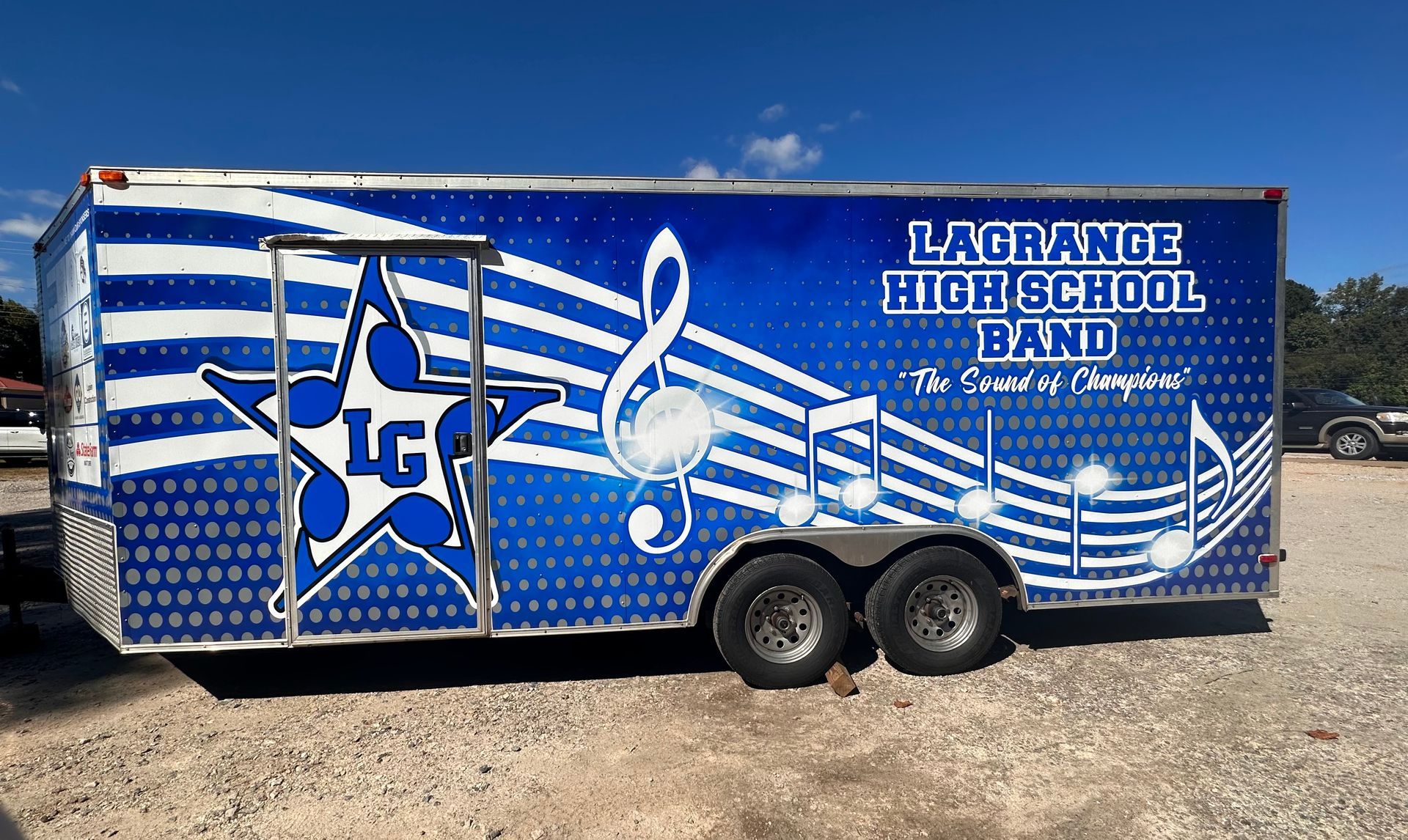 full custom printed trailer wrap in blue with white and gray graphics and text