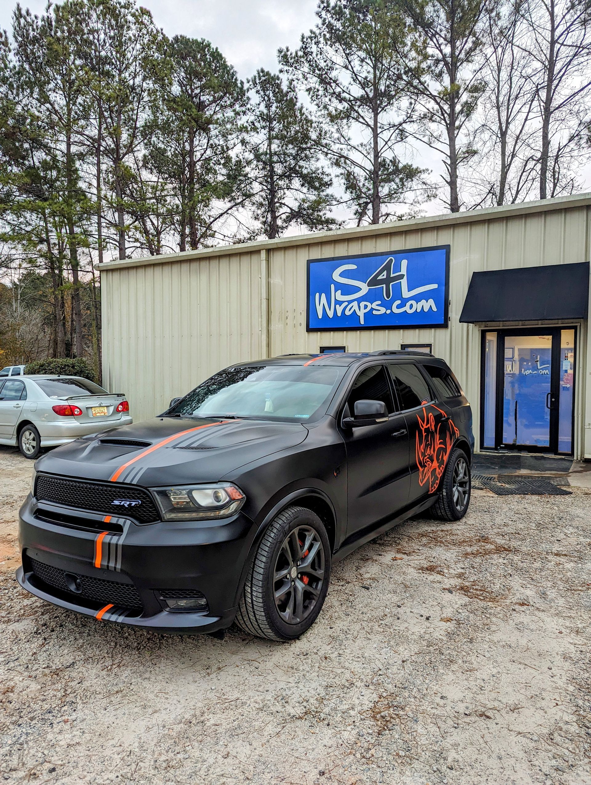 full black color change wrap with orange  stripes and rhino graphic