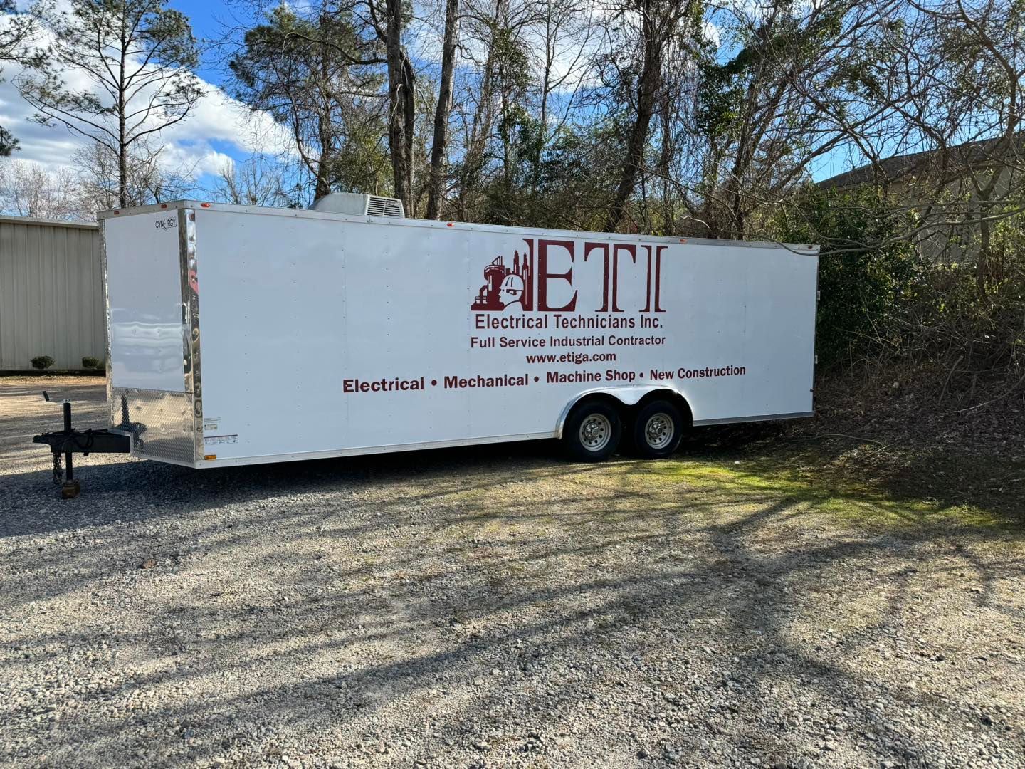 red cut vinyl logos and  lettering on white trailer