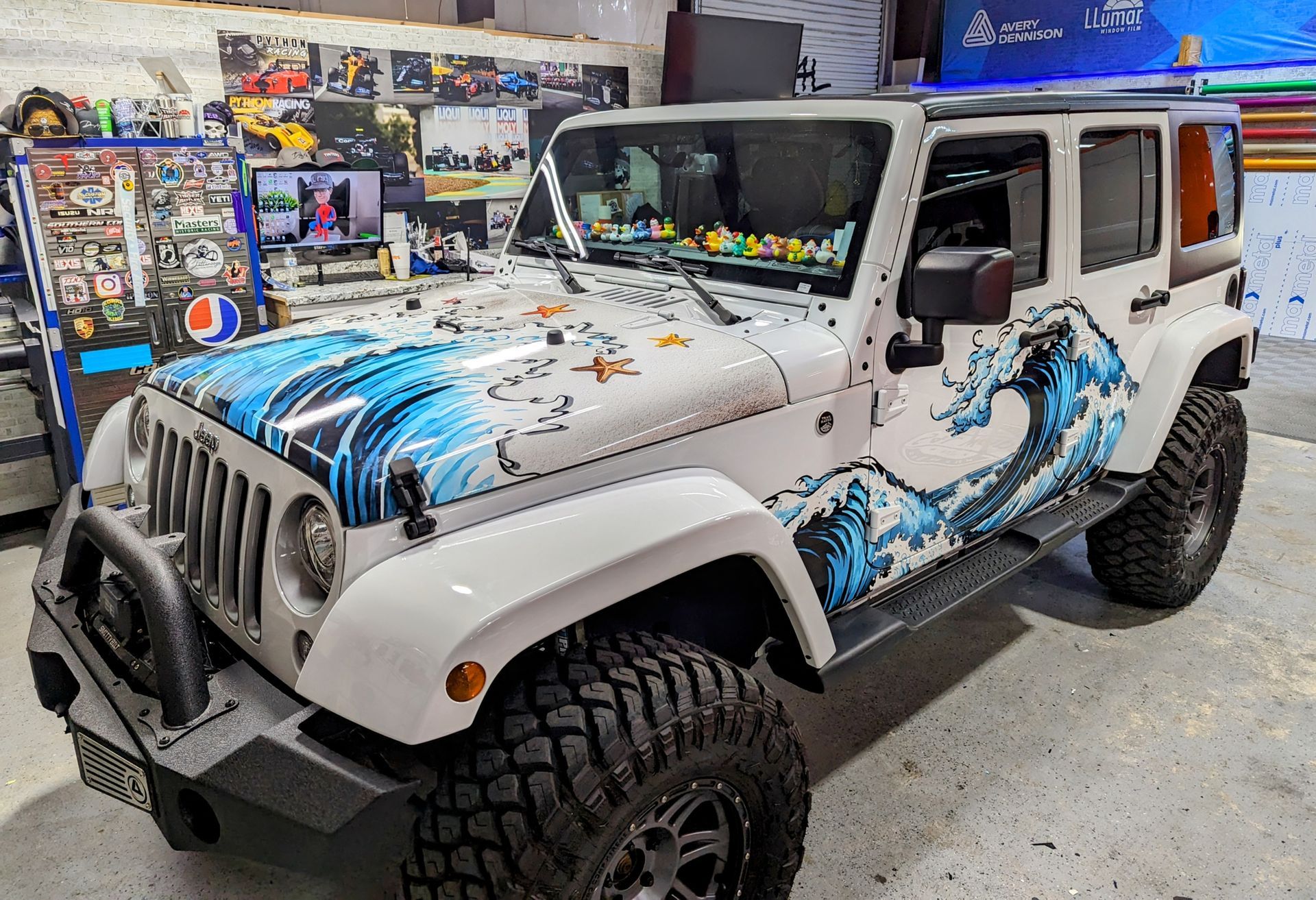white jeep with custom printed wave graphics