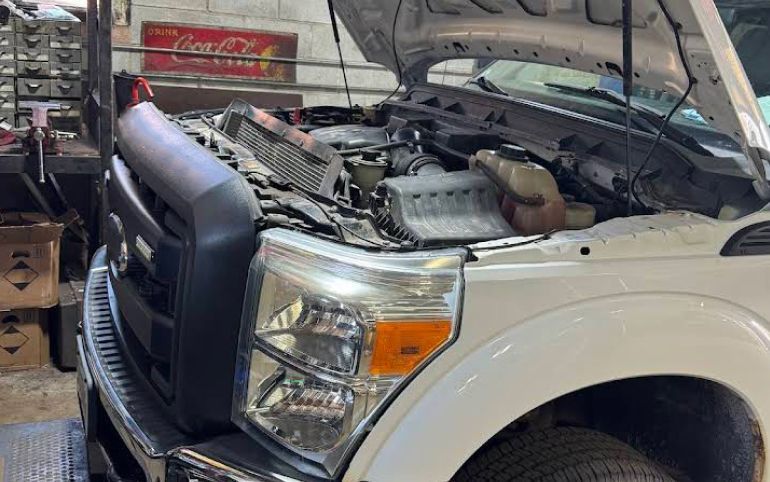 White Ford truck with hood open, showing engine | S&C Automotive Inc