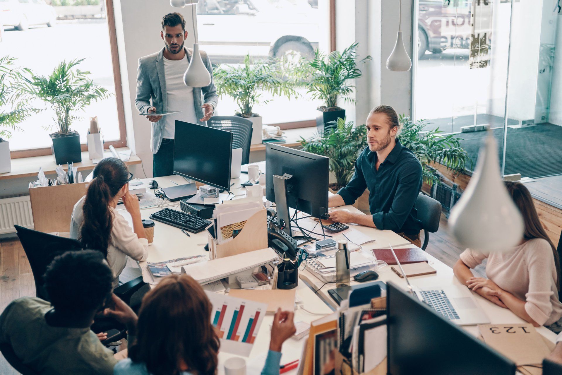 People in meeting sitting at computers