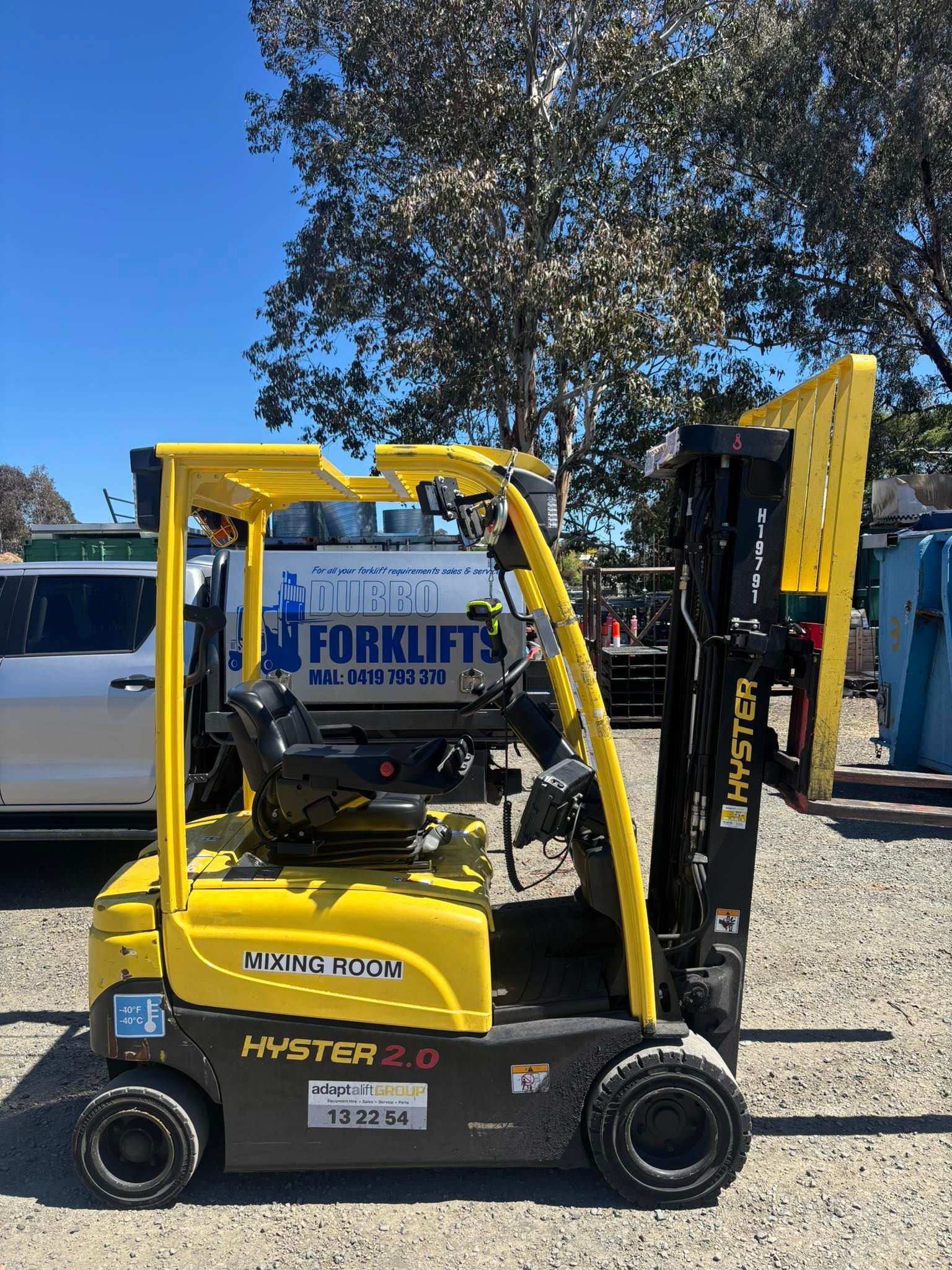 Yellow Hyster forklift outdoors on a sunny day.