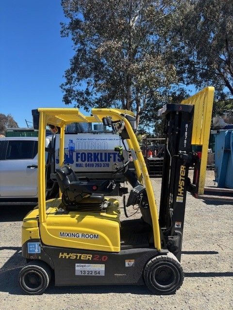 Yellow Hyster 2.0 forklift with black accents outdoors on a sunny day.