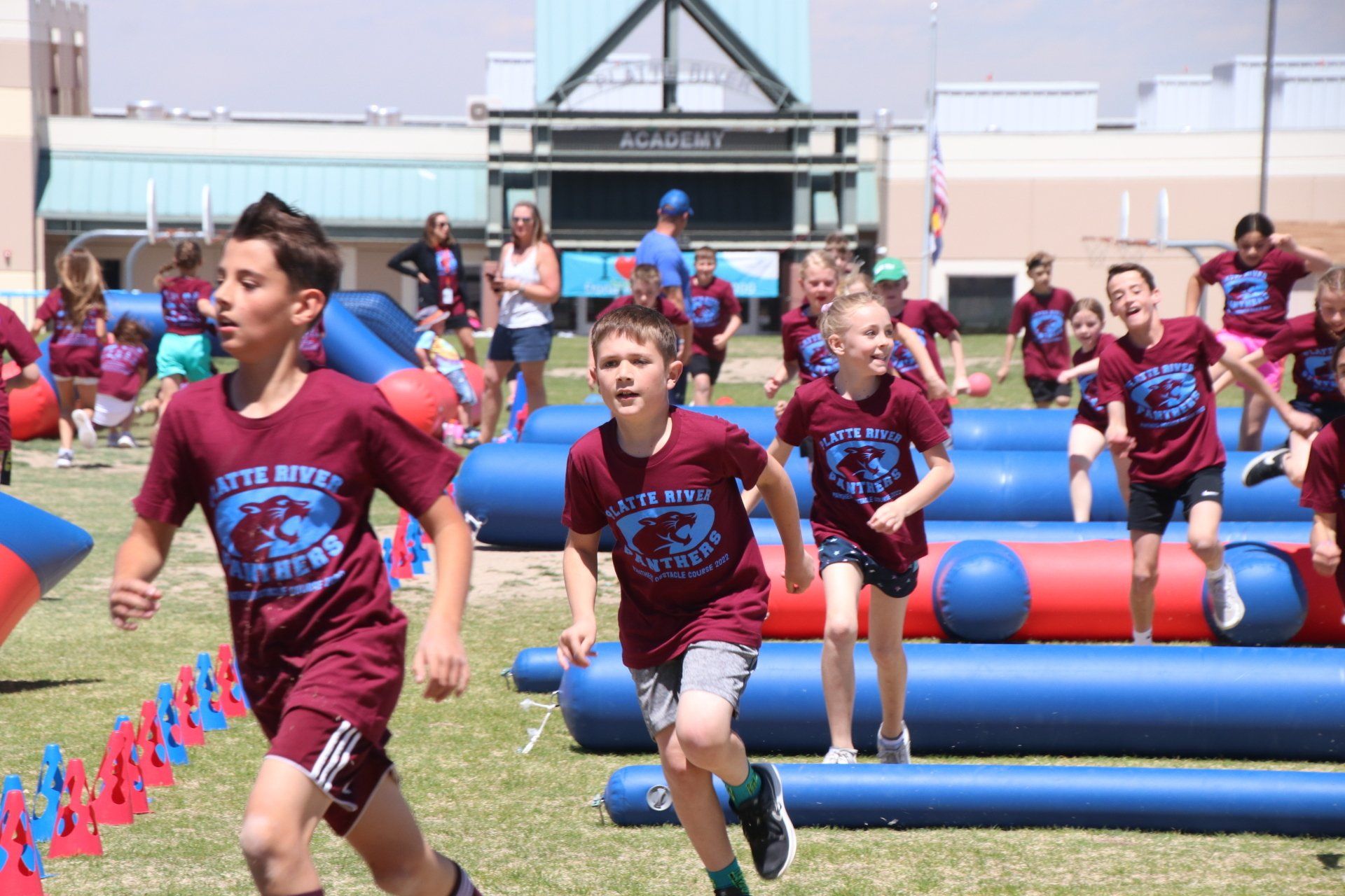 A group of children are running on a field.