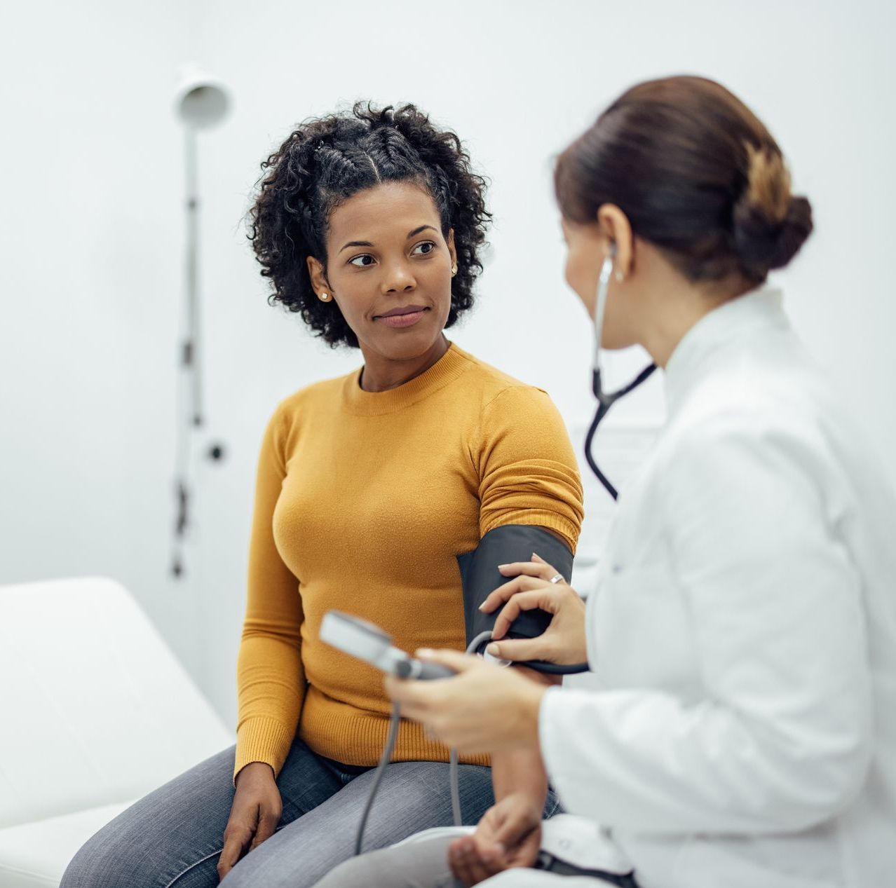 female doctor and female patient having a medical exam in clinic