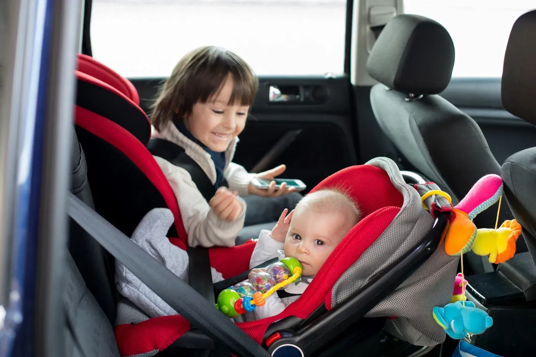 A Blue Baby Seat Is Mounted in The Back Seat of A Car — Mobility Modification Services In Garbutt, QLD