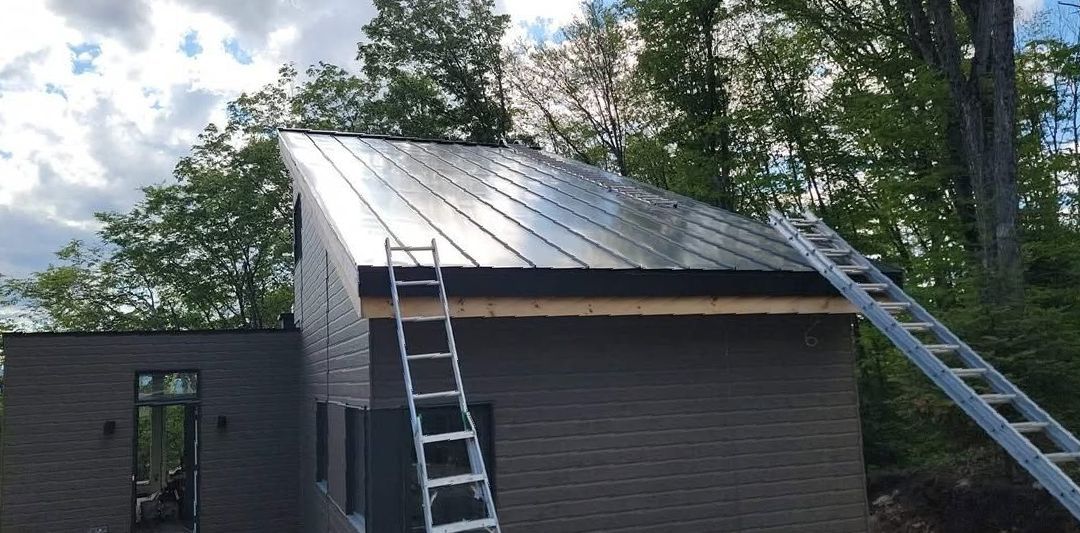 Une échelle est posée sur le toit d'une maison.