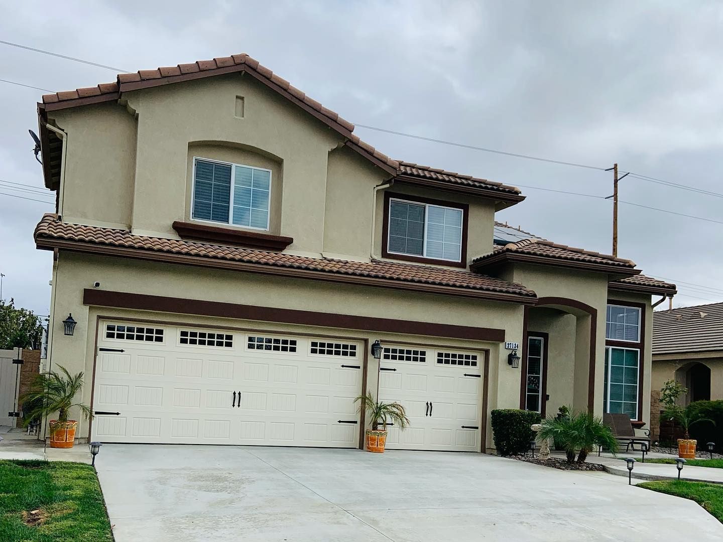 A large house with three garage doors and a driveway