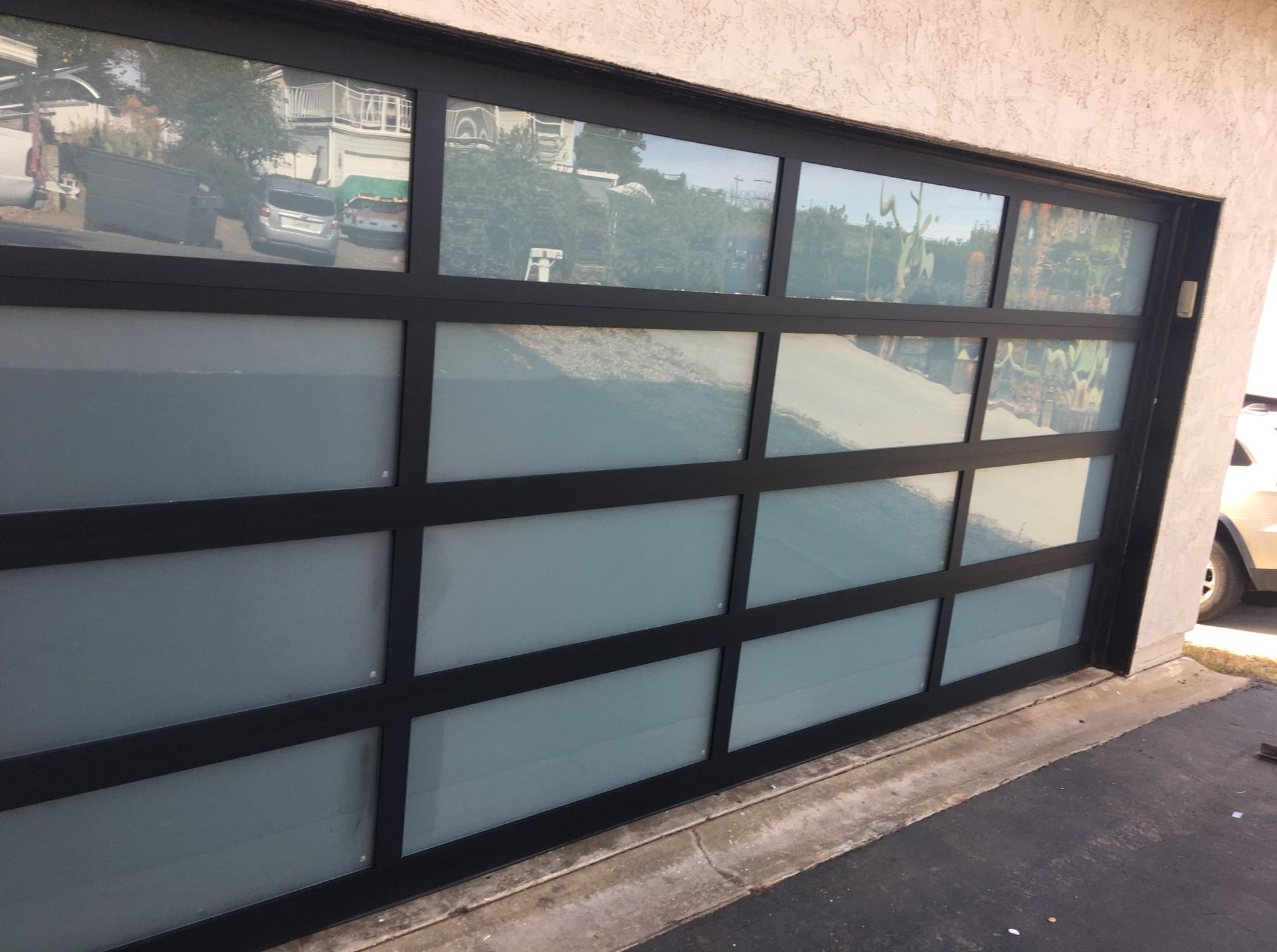 A black garage door with a lot of windows