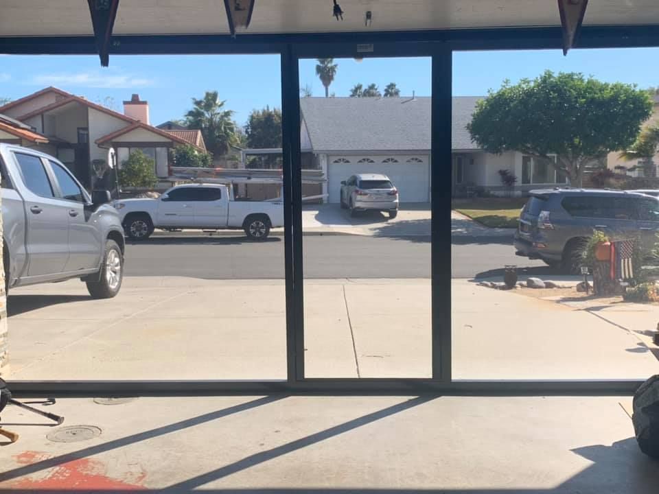 A truck is parked in front of a garage door.