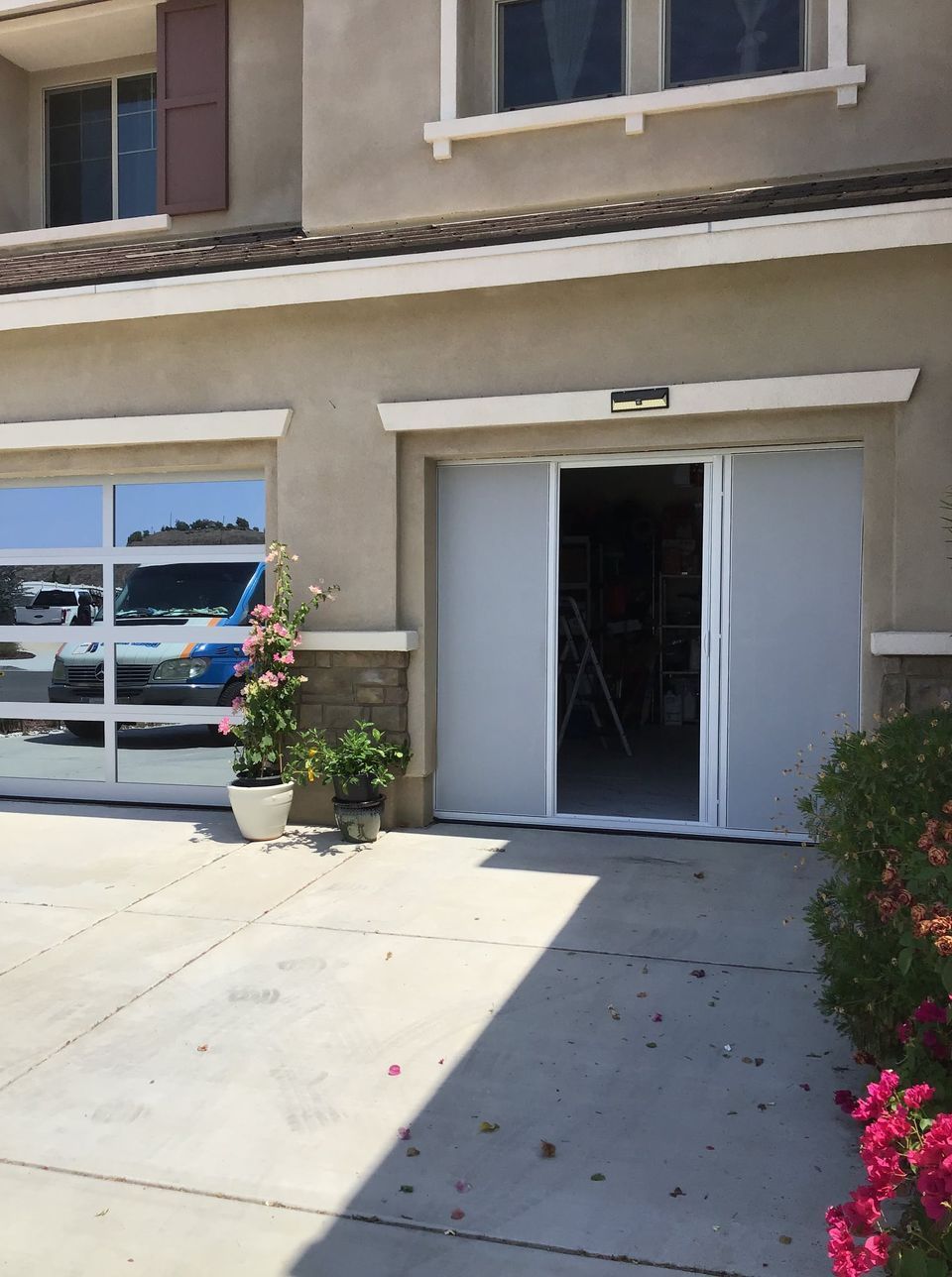 A house with a garage door that is open