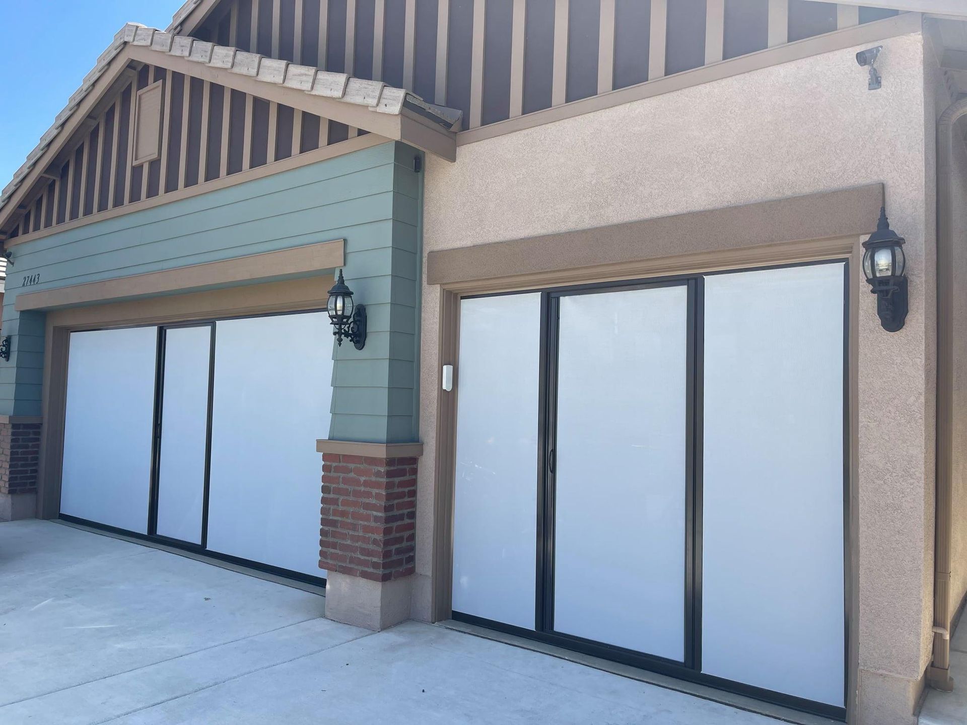 A house with two garage doors that are open
