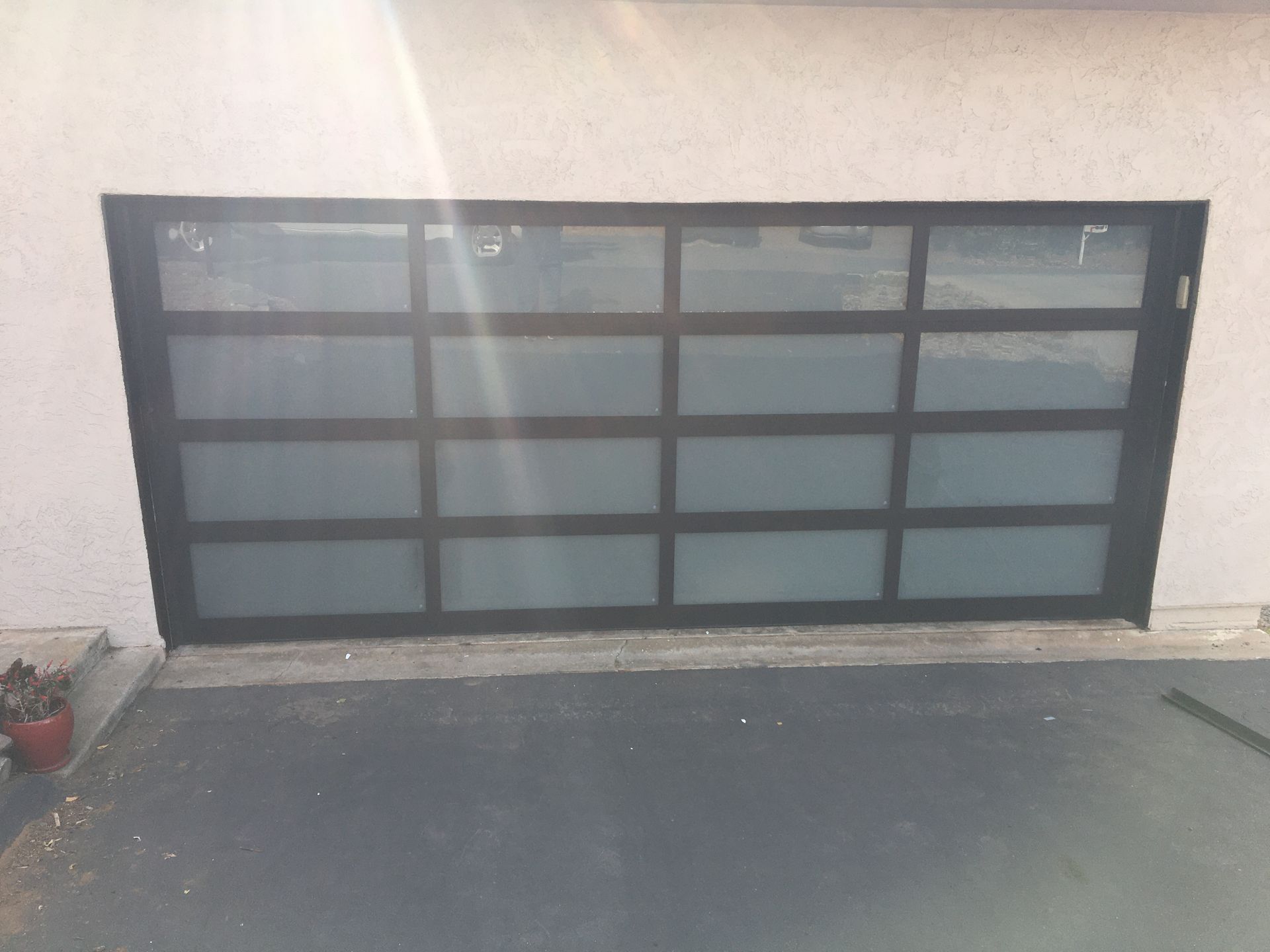 A black garage door with a lot of squares on it