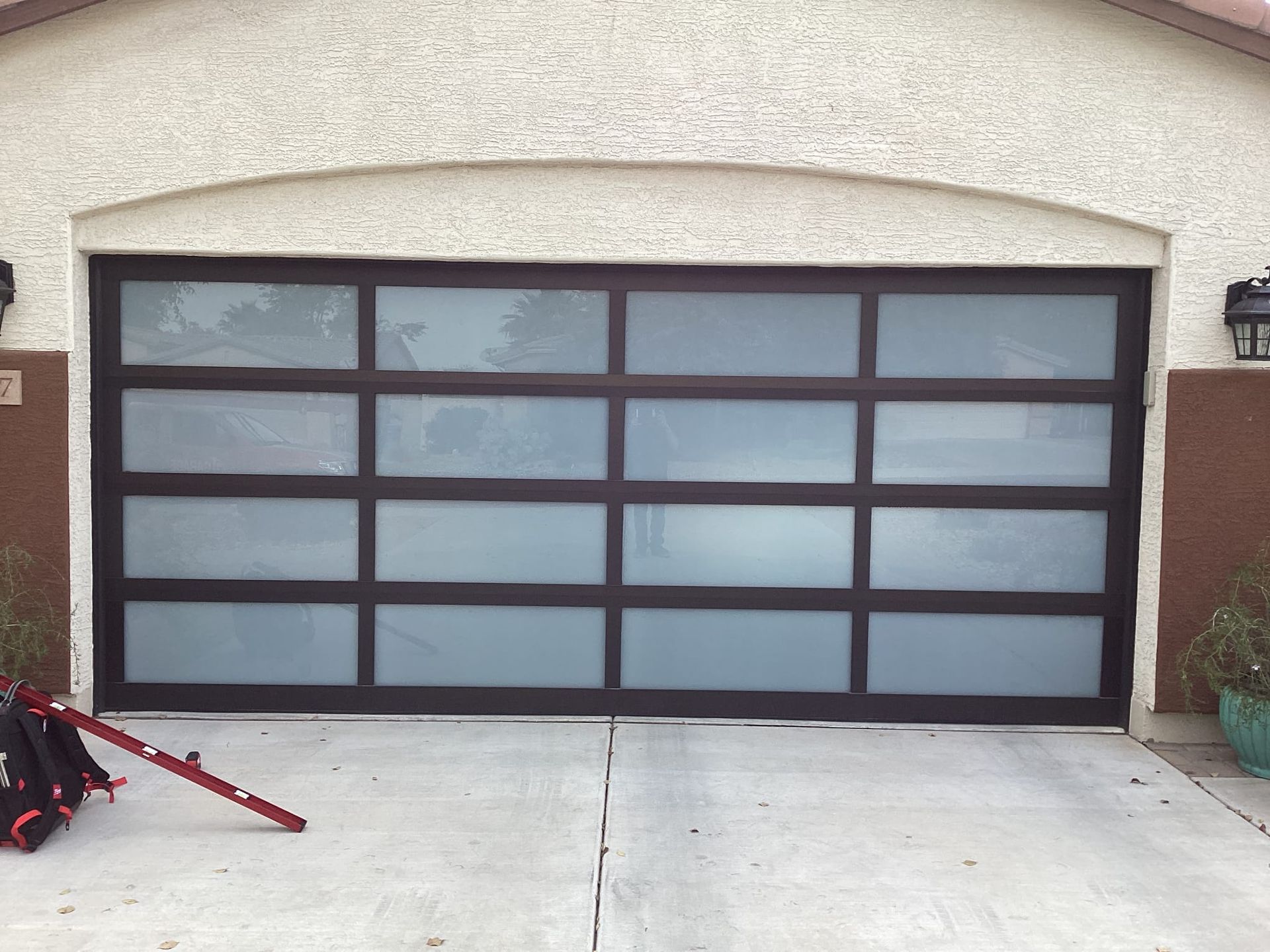 A garage door with a ladder in front of it