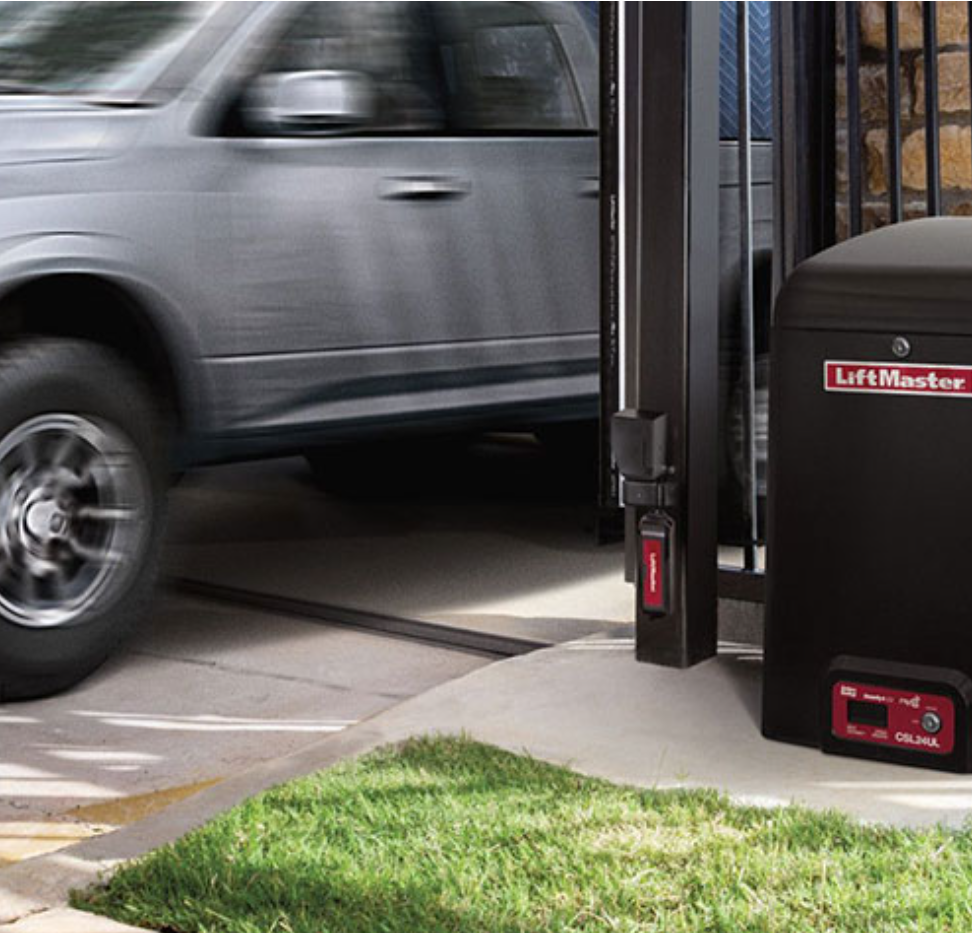 A car is parked in a driveway next to a liftmaster garage door opener