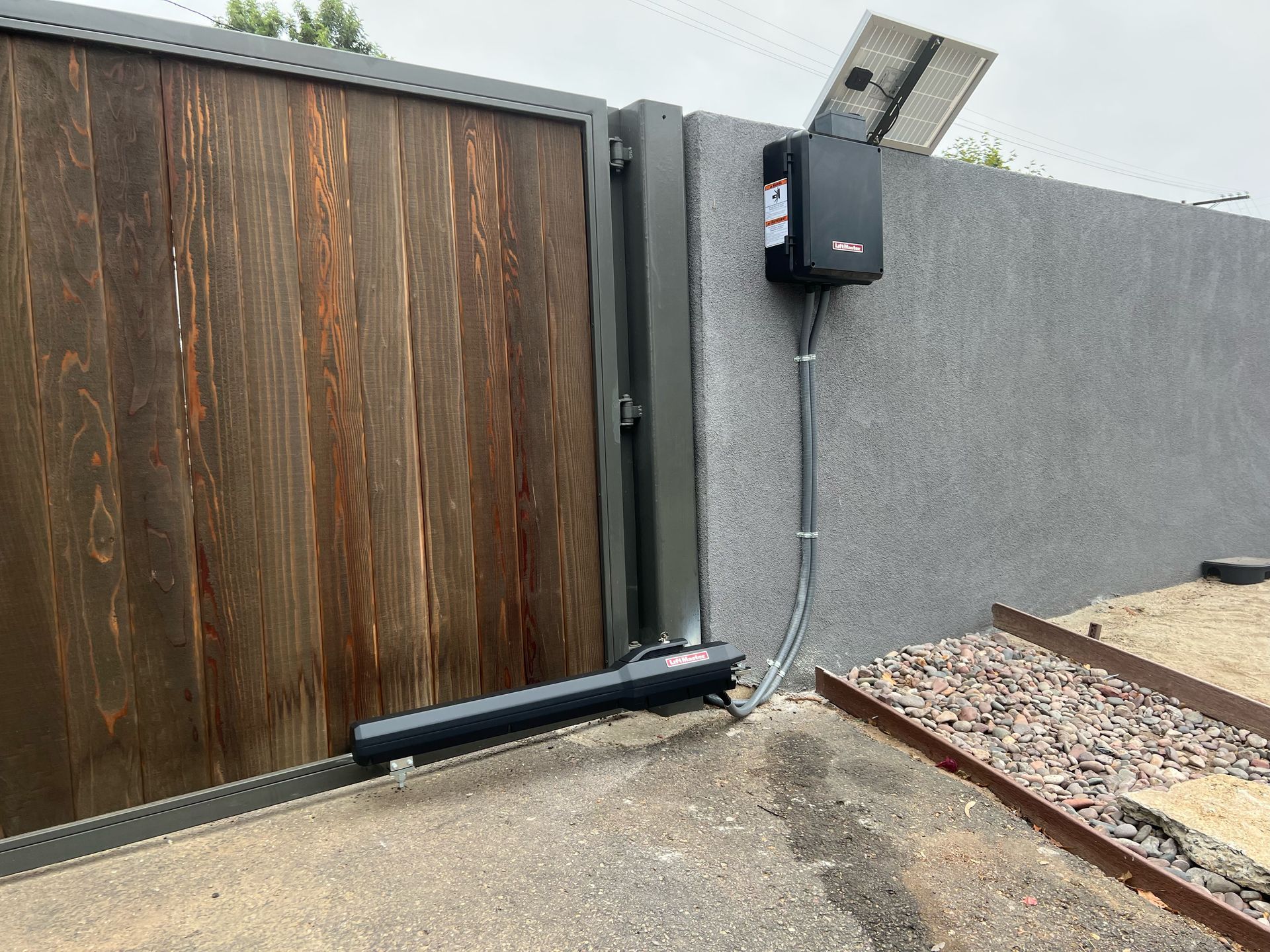 A sliding gate with a solar panel attached to it.