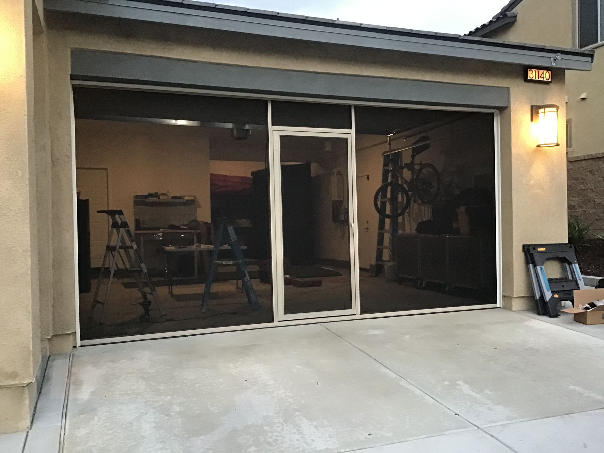 A screened in porch with a sliding glass door