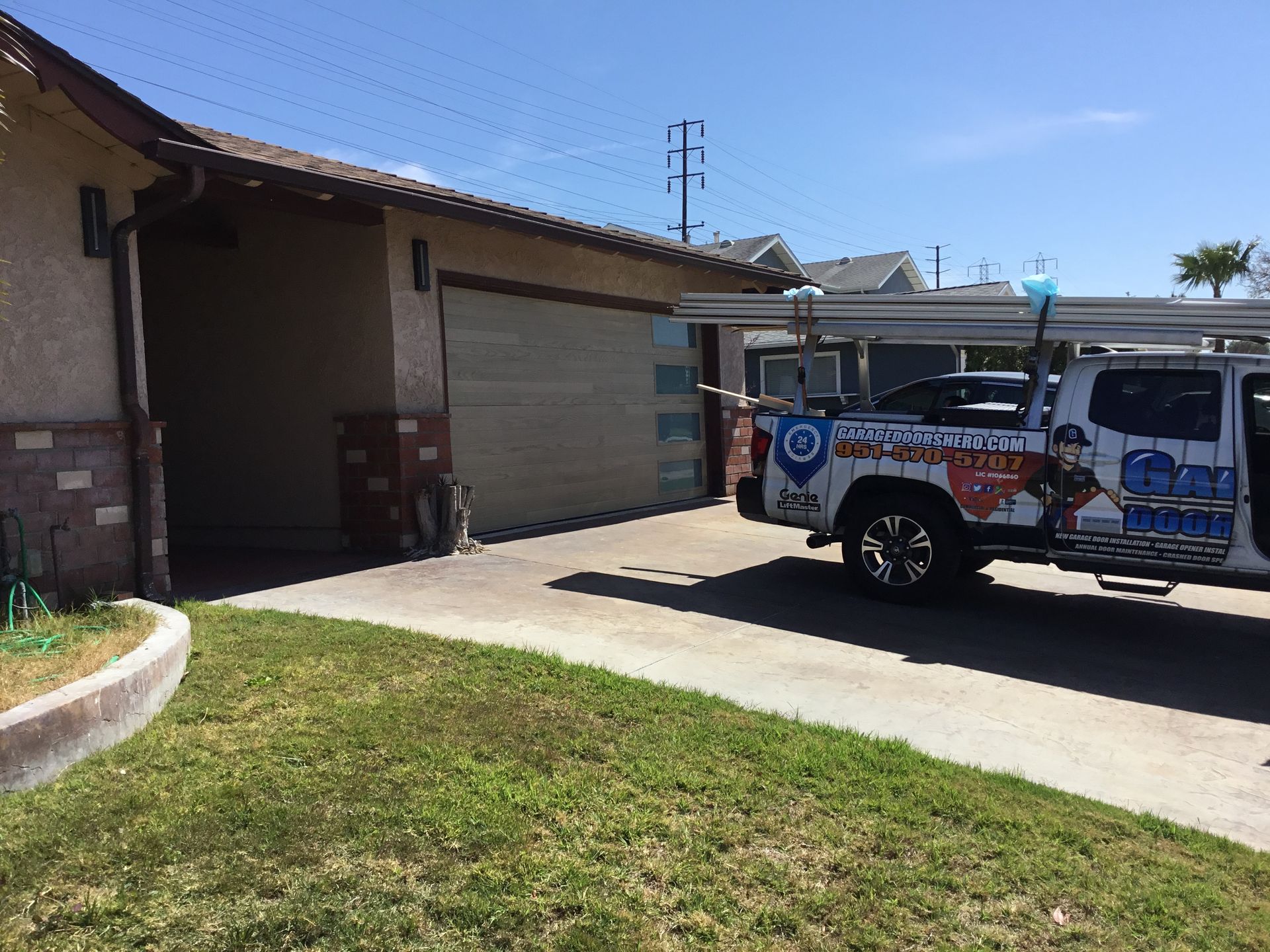 A truck is parked in front of a house in a driveway.