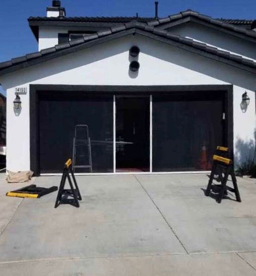 A white house with a sliding garage door