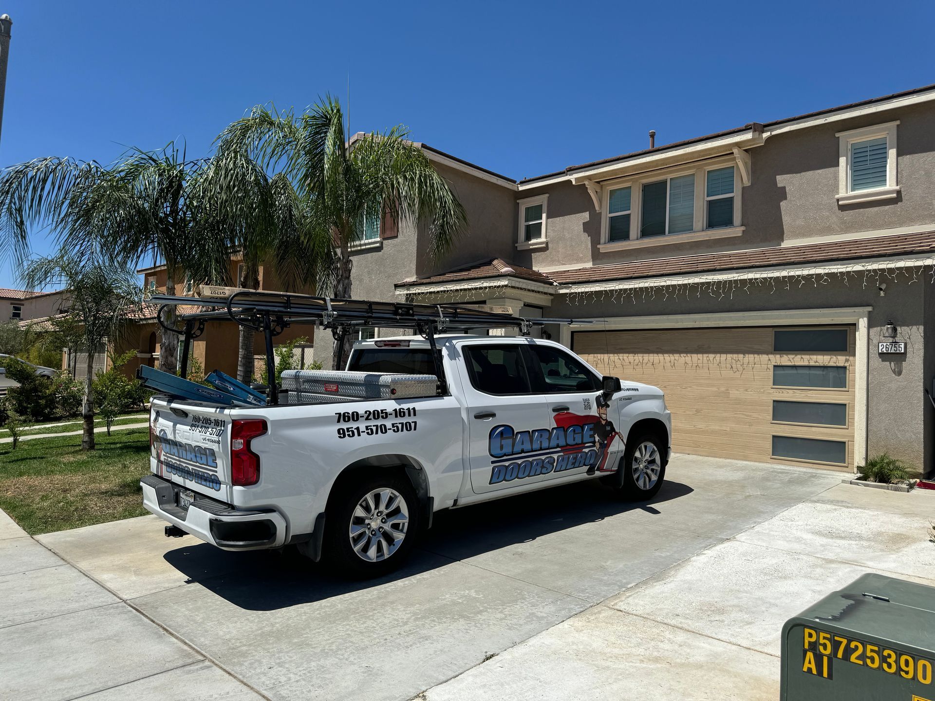 A white truck is parked in front of a house.