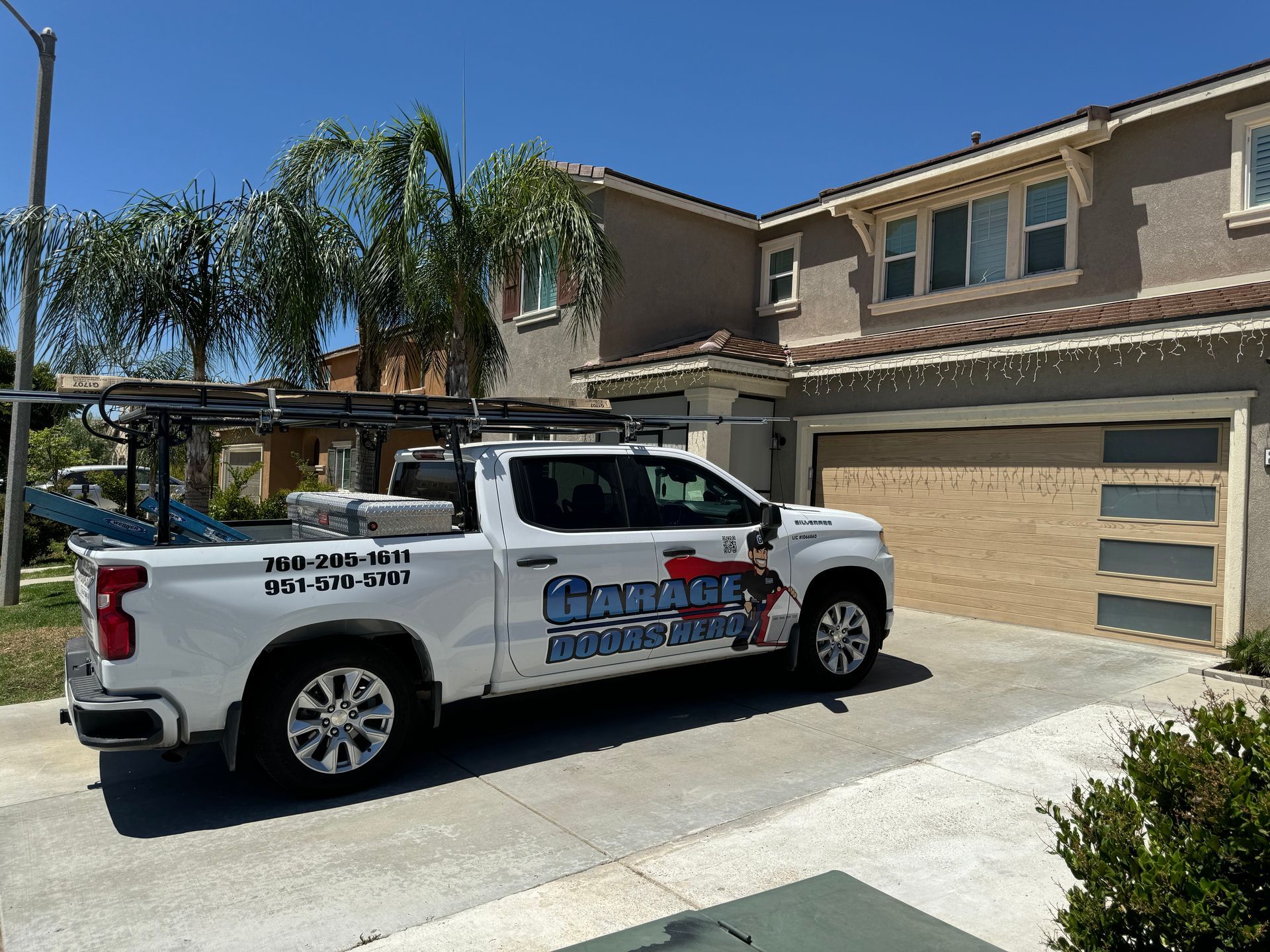 A white truck is parked in front of a house.