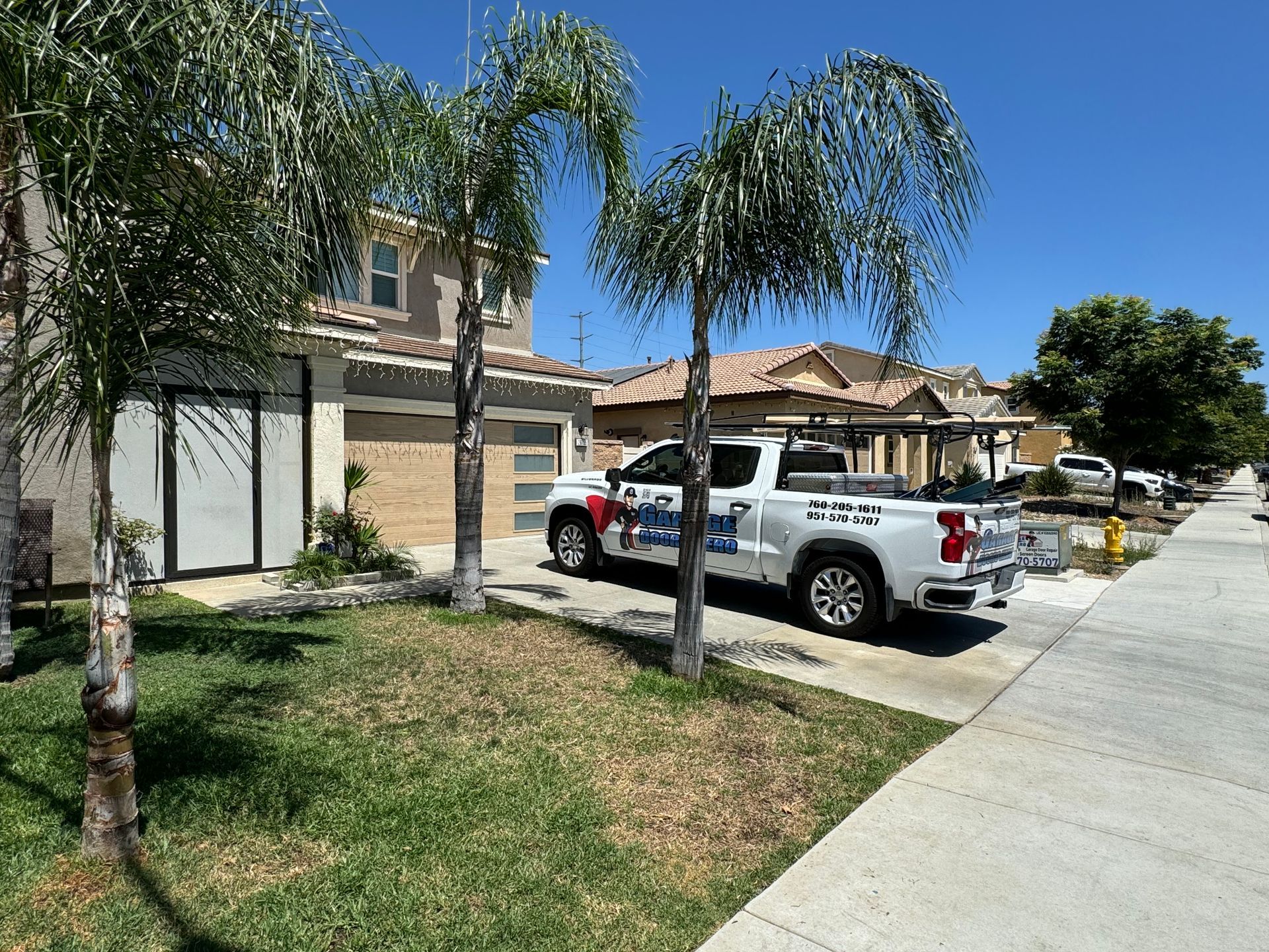 A white truck is parked in front of a house.